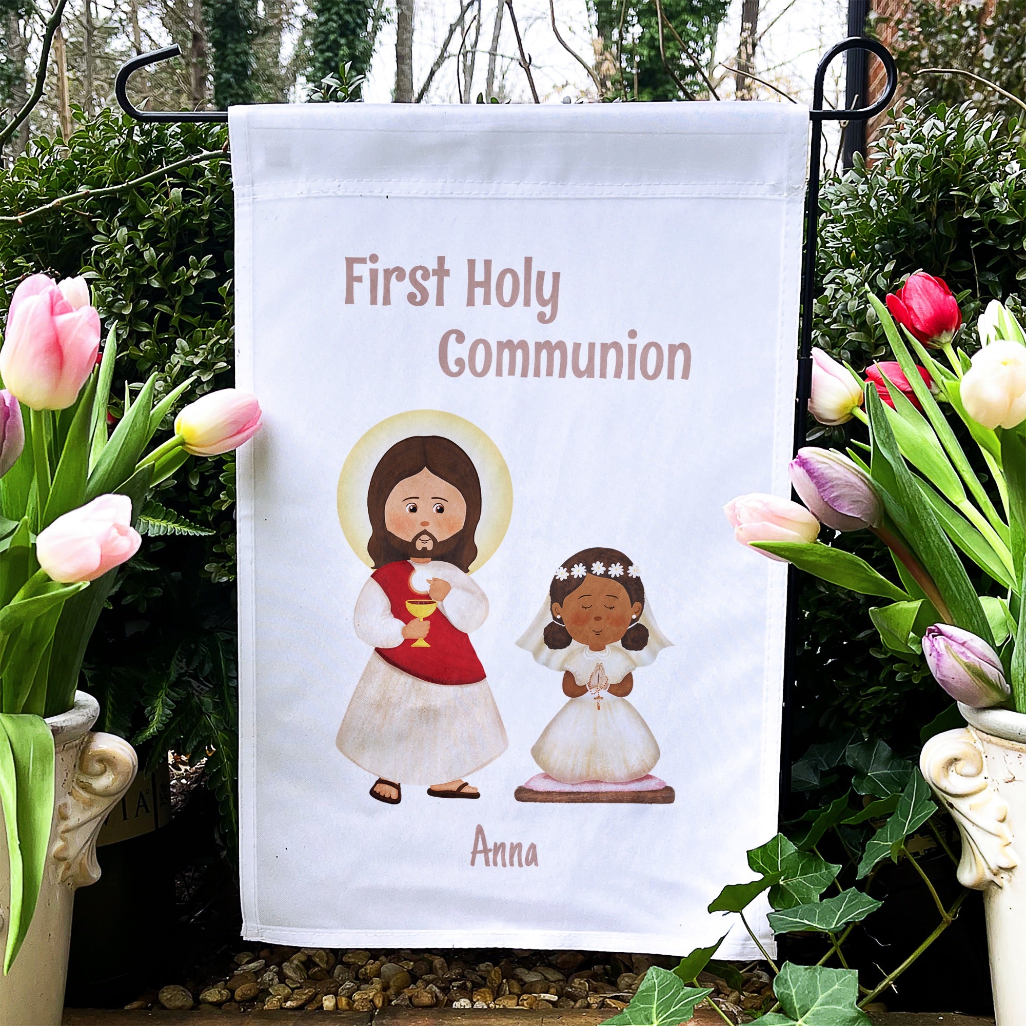 White garden flag celebrating First Holy Communion features Jesus and a girl, with "Anna" printed at the bottom.