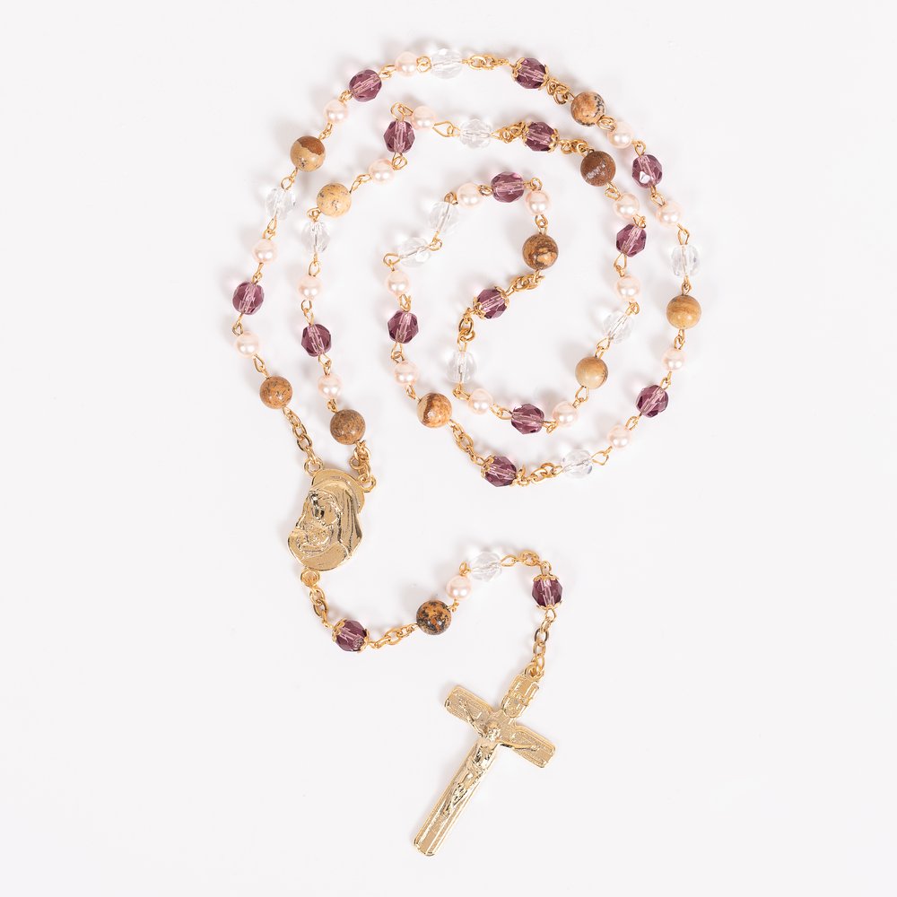 Gold rosary featuring purple, pearl, clear, and brown beaded accents with crucifix and Virgin Mary medal.