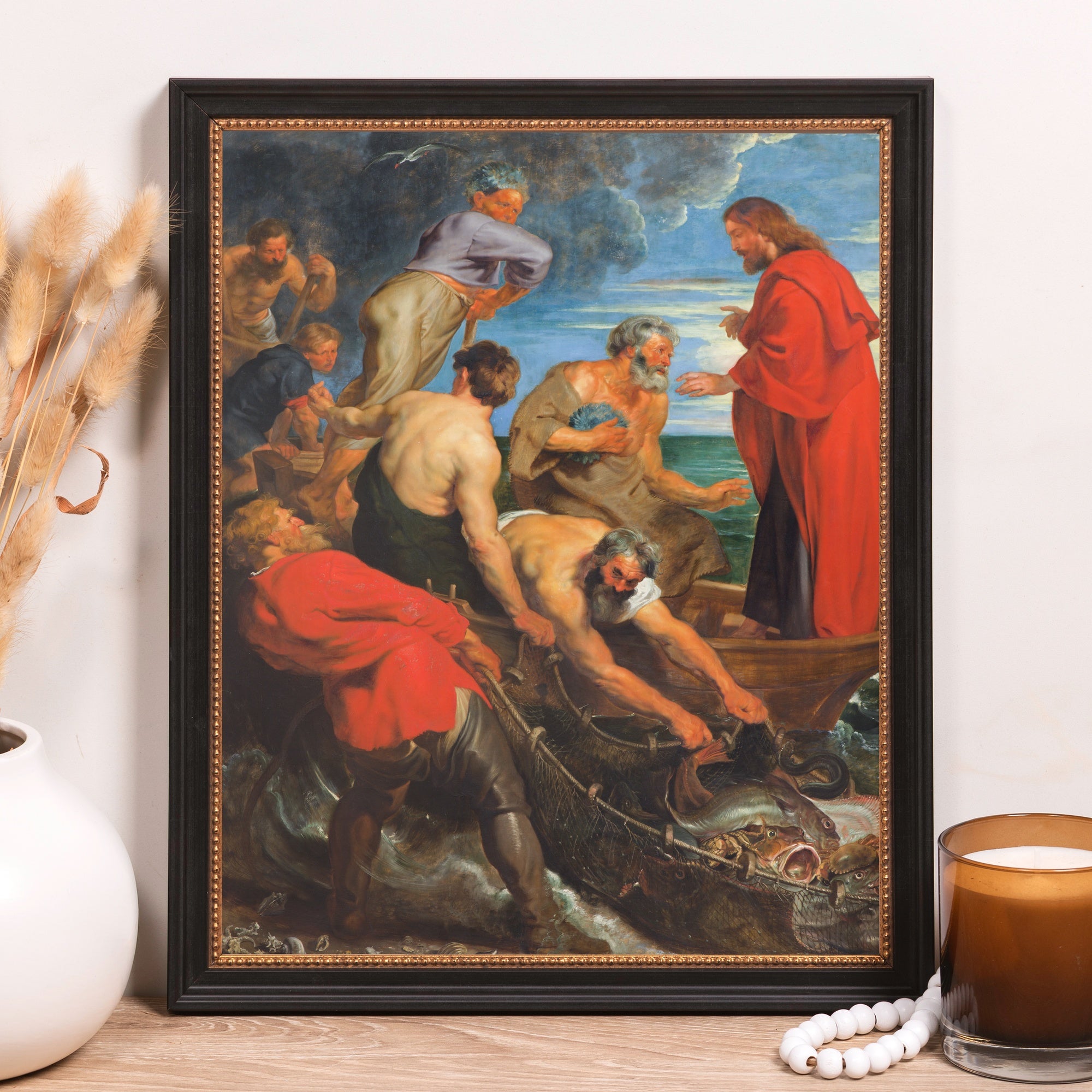 Framed print of Christ and the fishermen, an oil painting style in a black frame with gold trim.