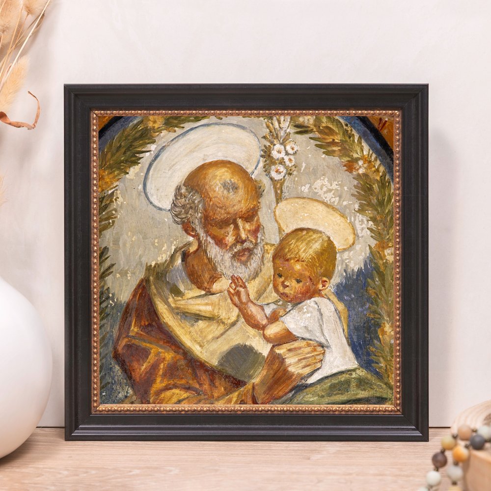 Framed painting of St. Joseph and baby Jesus with black frame, aged style, muted colors, and halo.