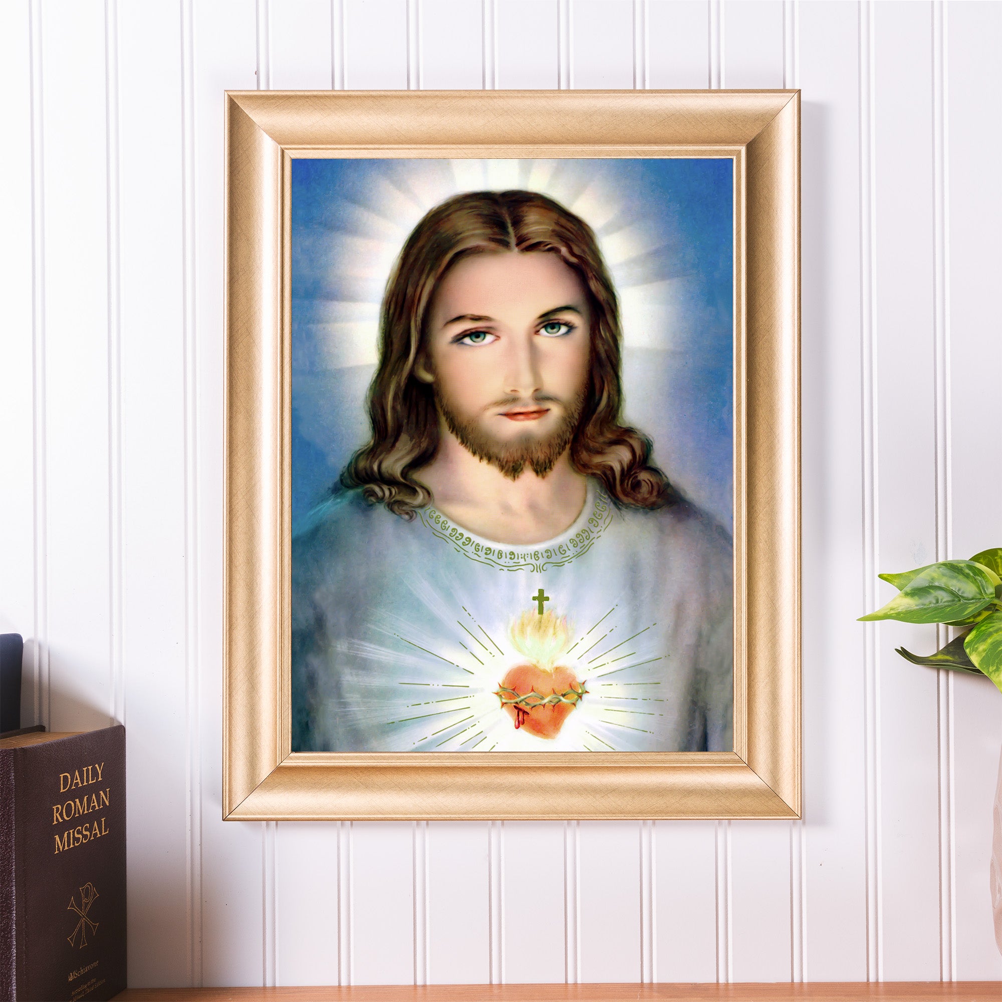 Framed art print depicts Jesus with a sacred heart, painted style, in a gold frame.