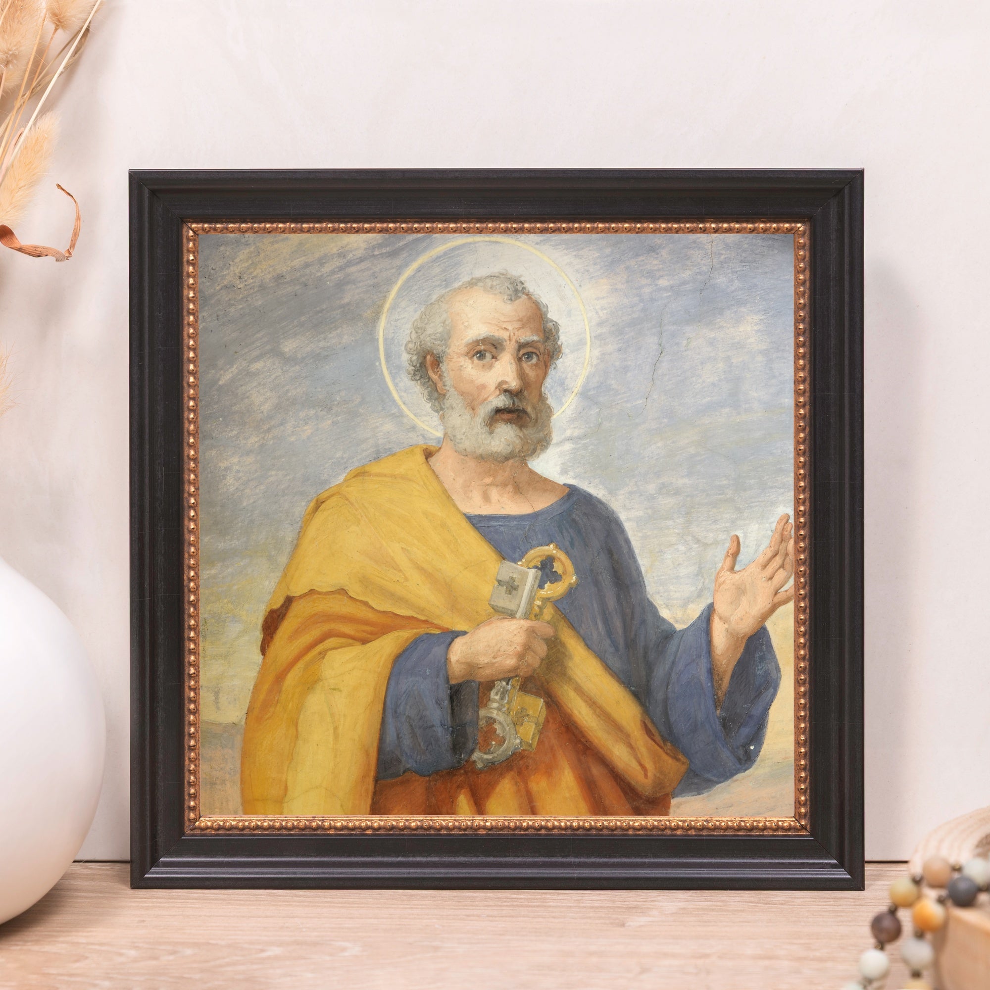 Framed art print depicting a man with keys in a black and gold frame.