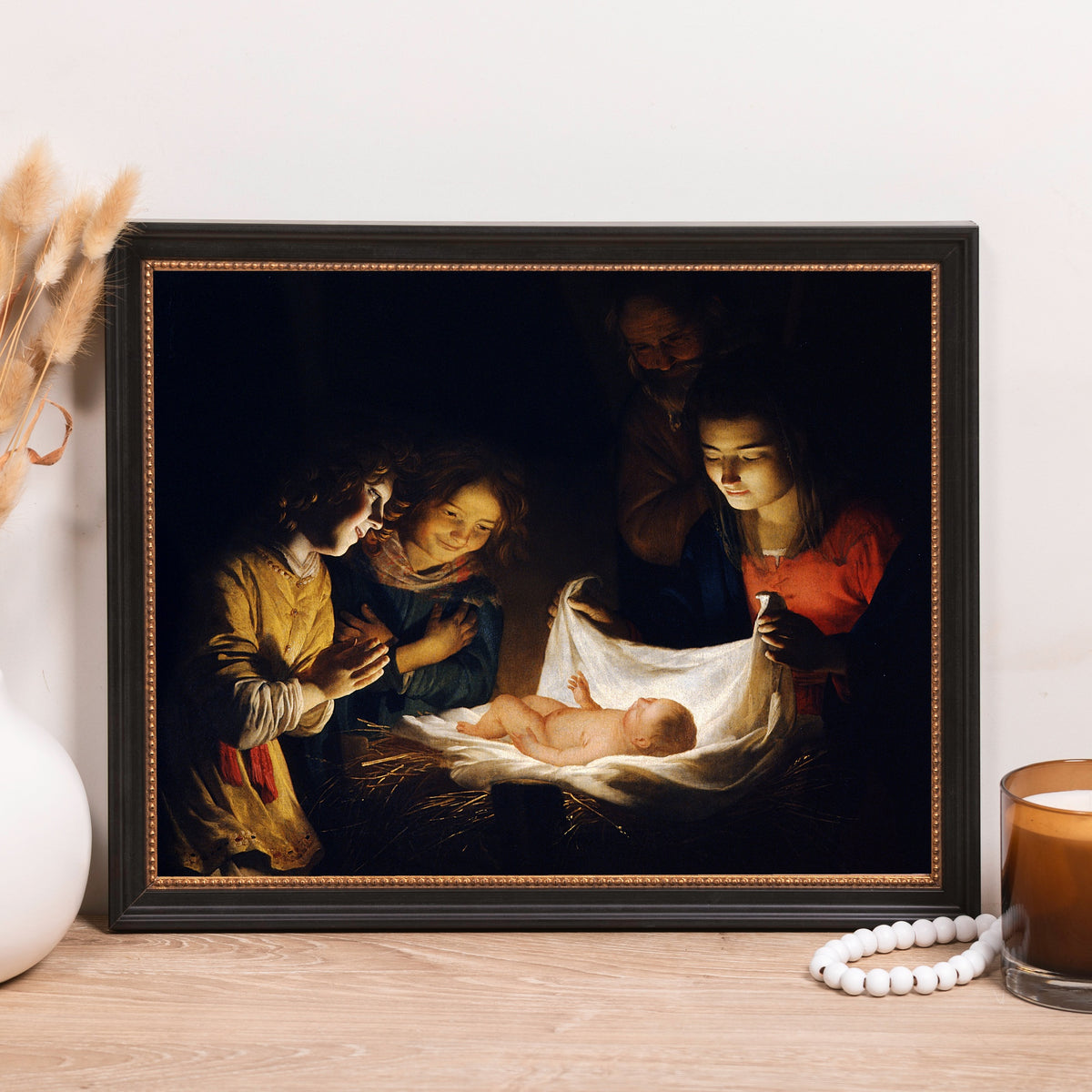 Framed Print of the Nativity painting in dark and muted tones with a black frame.