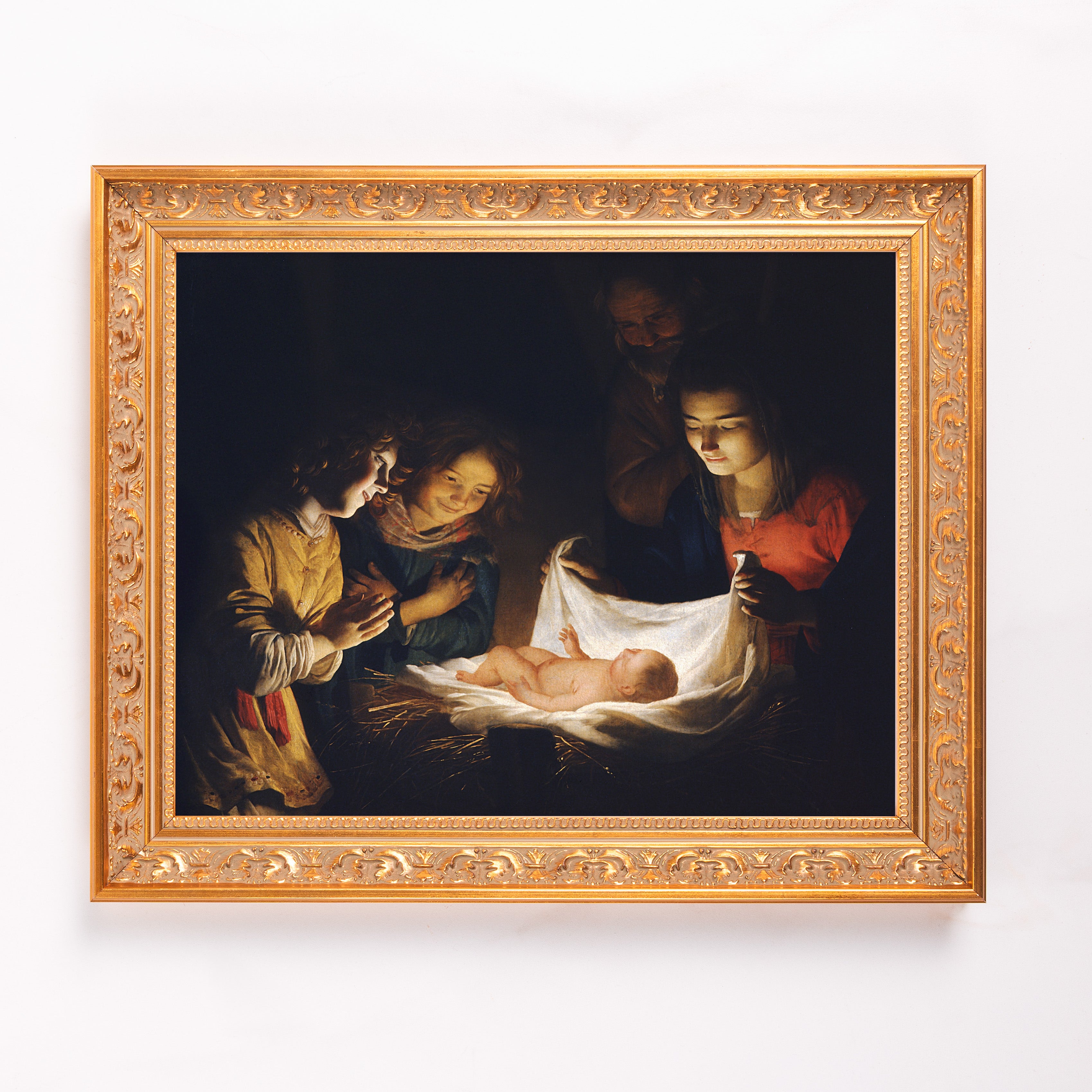 Framed Reproduction of the Nativity oil painting with gold ornate frame in a classical style.