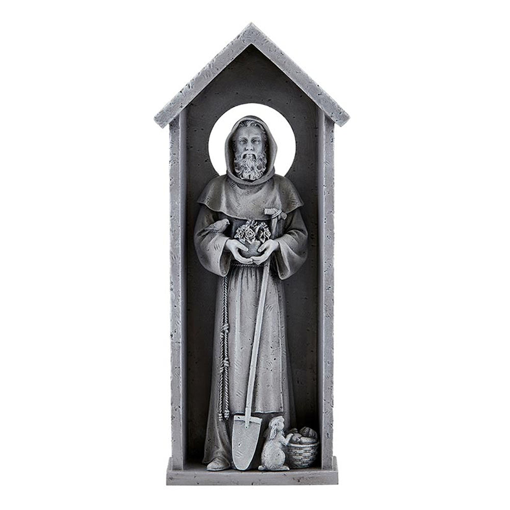 Gray statue of St. Francis in a stone-like frame holding flowers and a shovel with a bird and rabbit at his feet.