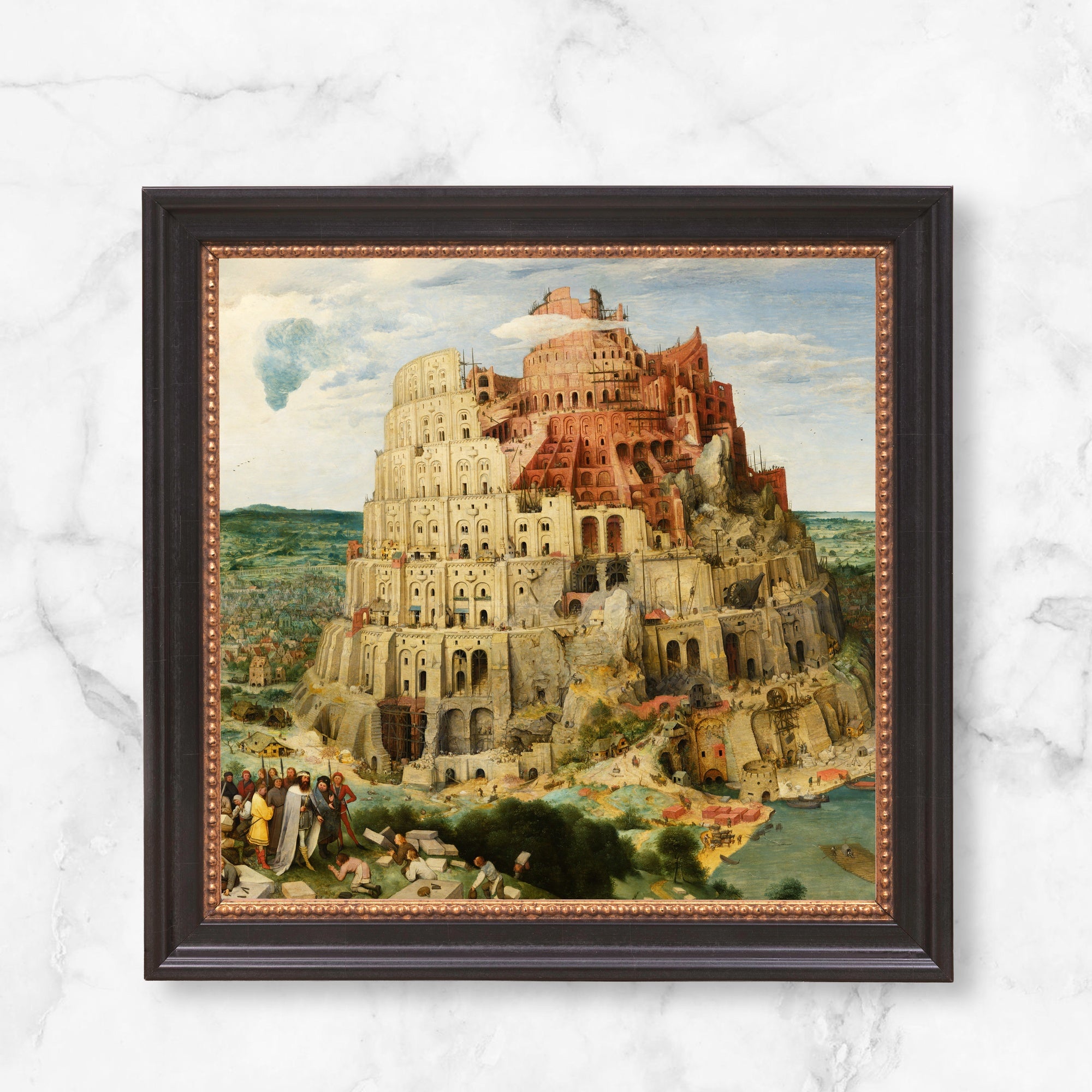 Framed Tower of Babel print. A historical scene in red, white and green, enclosed in a black and bronze frame.