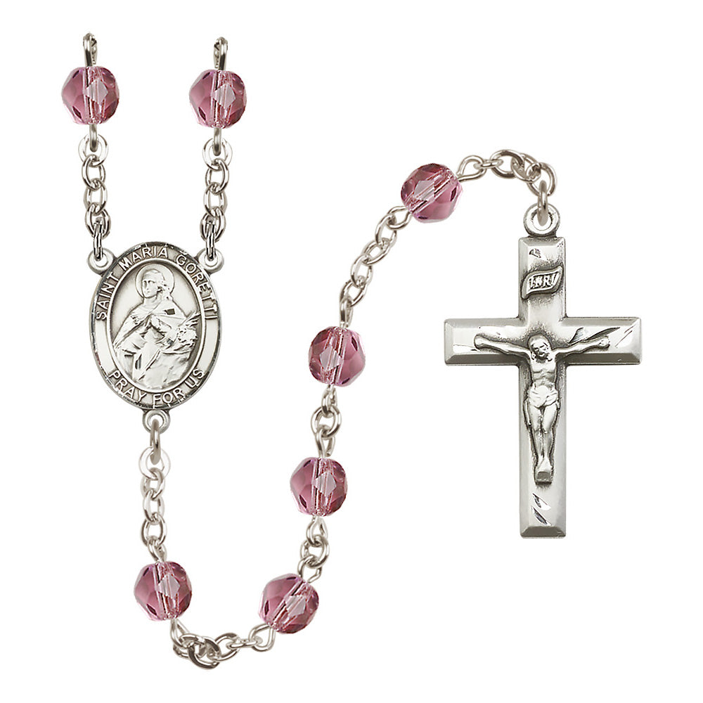 Silver rosary featuring Saint Maria Goretti medallion, crucifix, and faceted rose-colored beads.