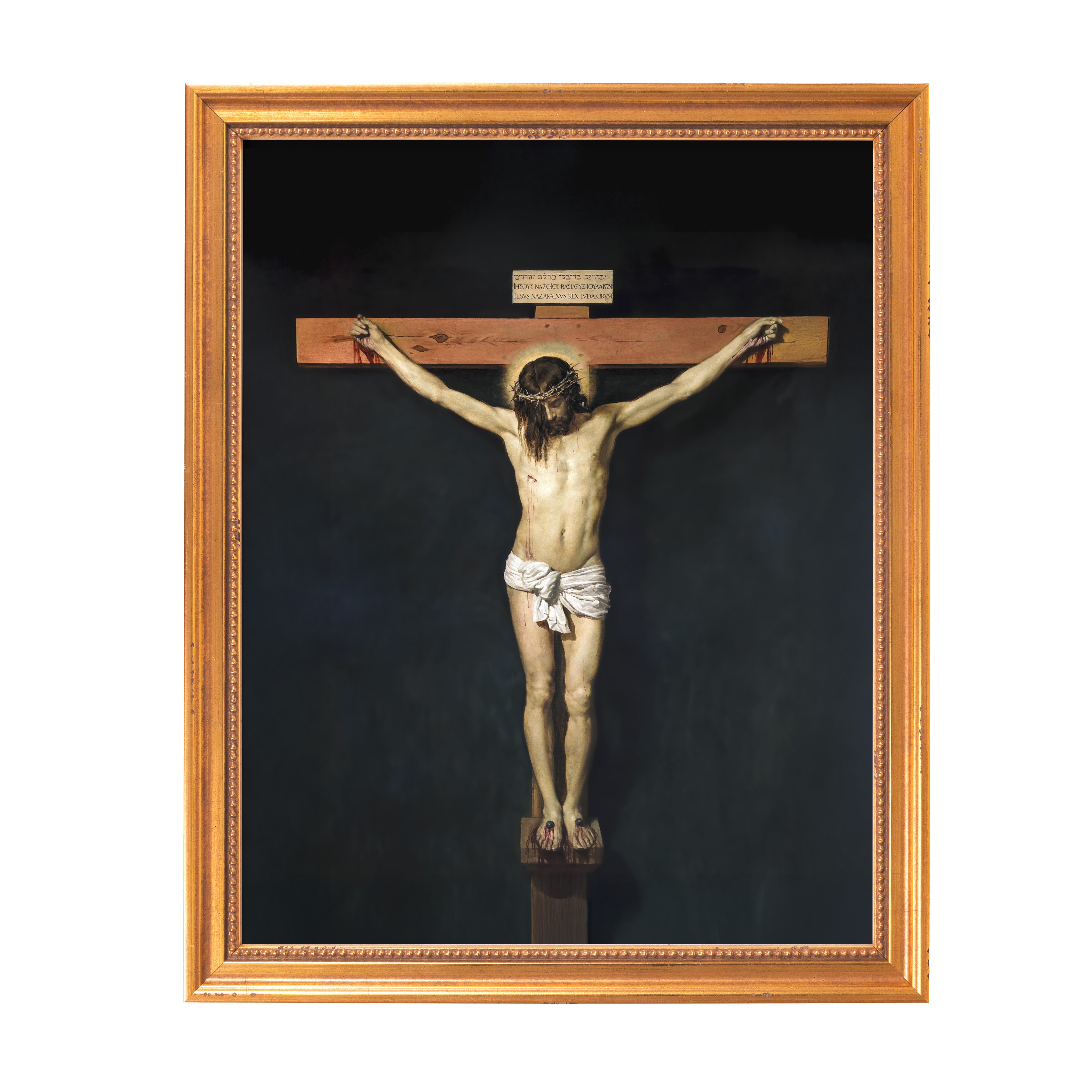 Framed Crucifixion art: Jesus Christ on a wooden cross, gold frame, dark background.