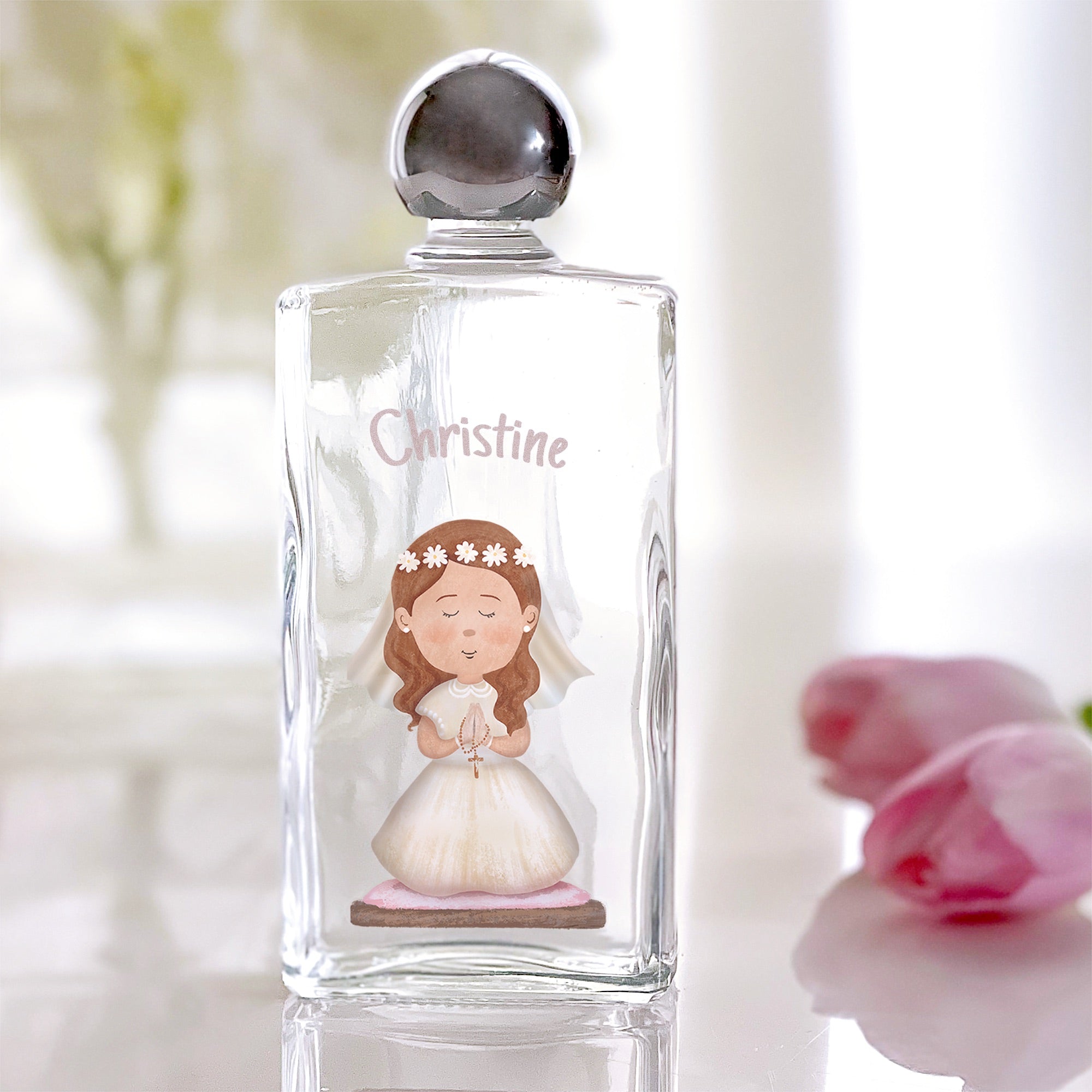 Clear glass holy water bottle with a chrome-like spherical top, featuring a girl and the name Christine.