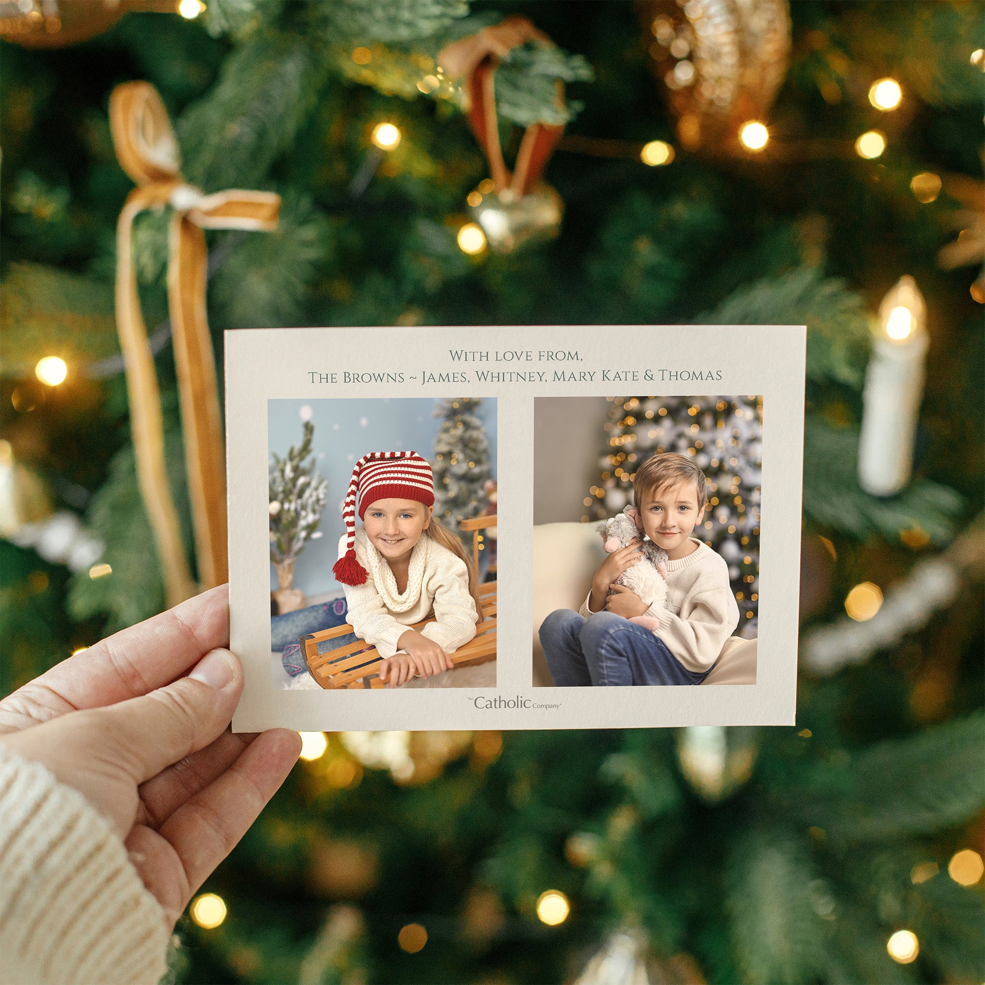 Holiday card with two kids' photos in a neutral color palette, displayed against a blurred Christmas tree background.