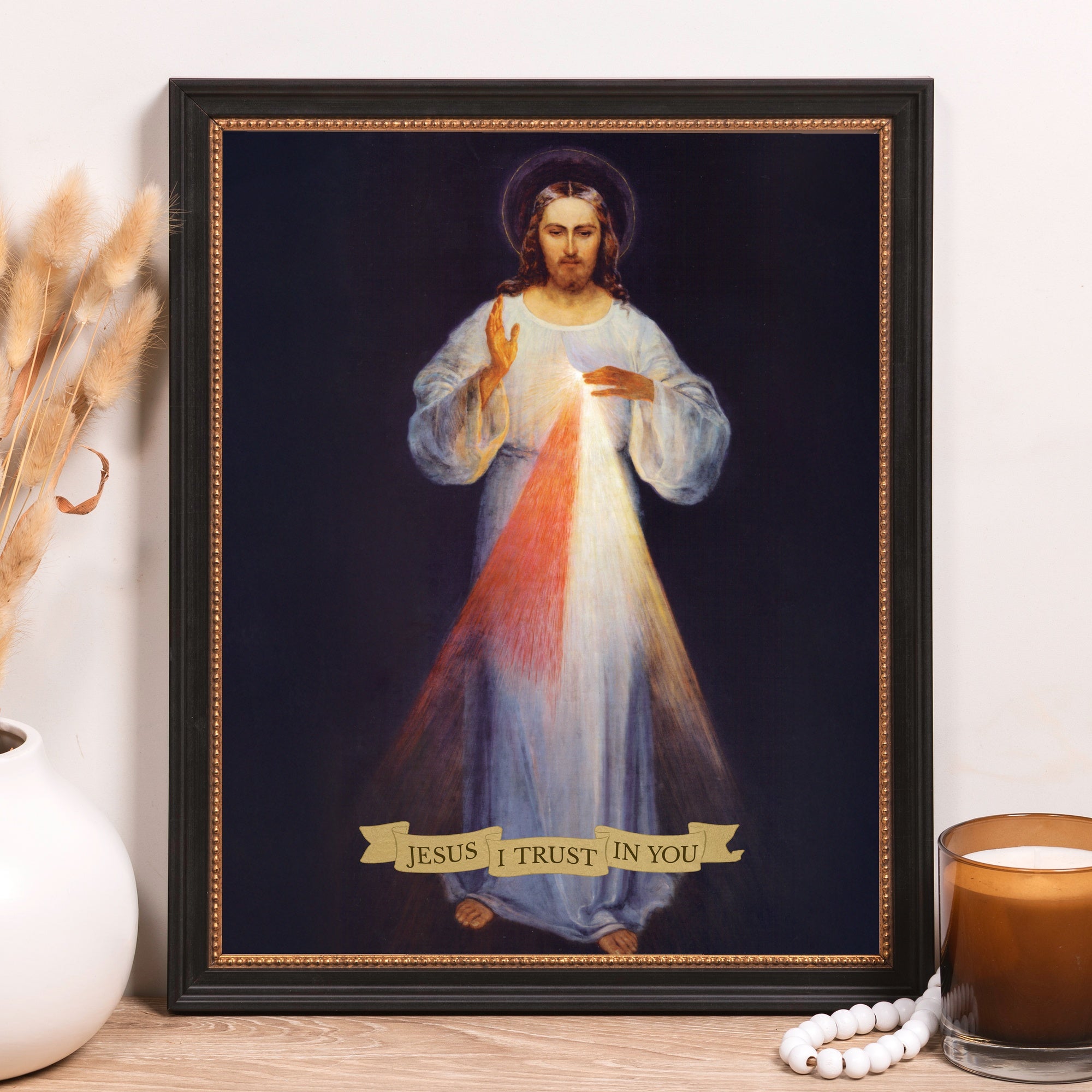 Framed art print of the Divine Mercy image with rays and "Jesus I trust in You" banner in a black frame.
