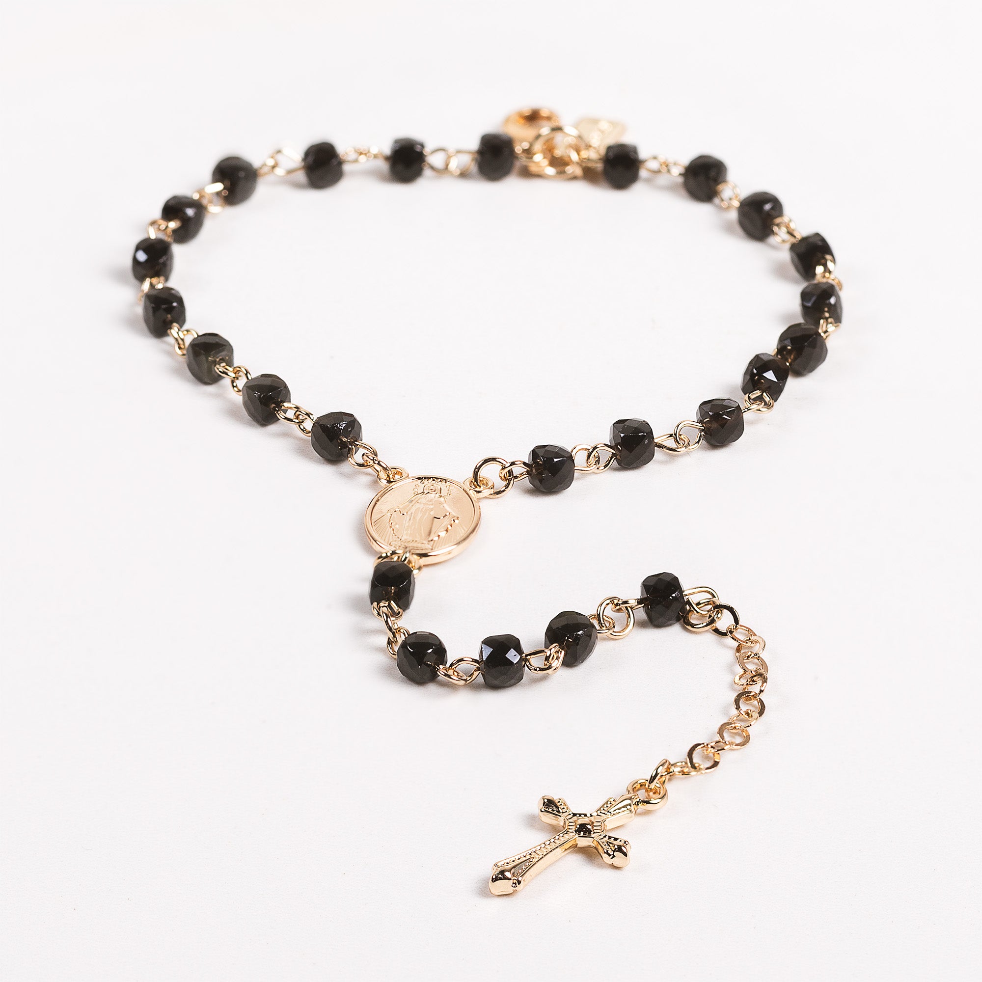 Rosary with black beads and a gold crucifix.