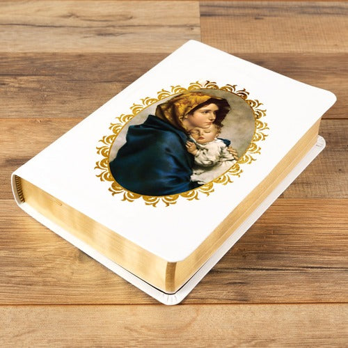 White, hardback prayer book with gold gilded edges. Depicts Mary and baby Jesus in a gold frame.