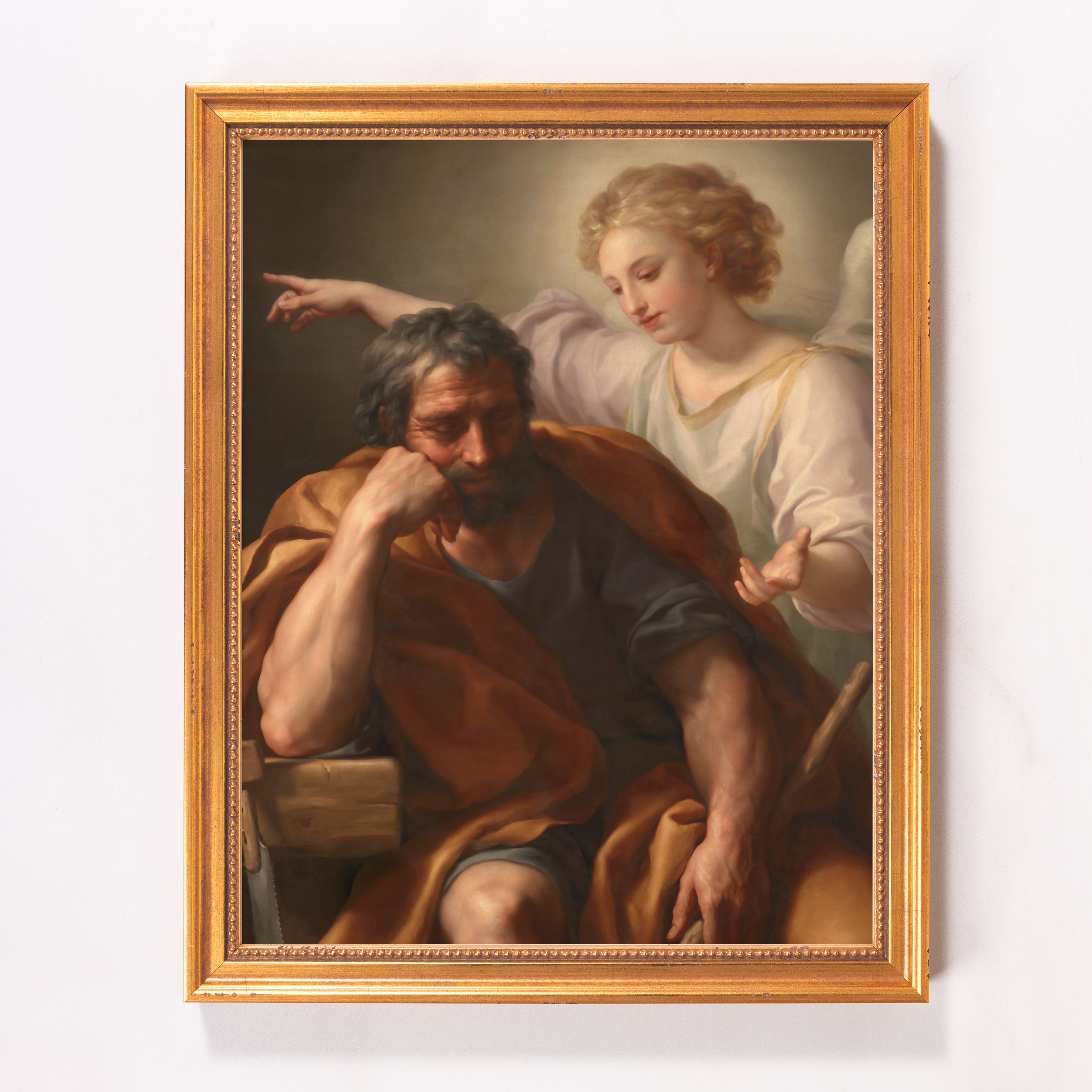 Framed painting depicts Joseph's Dream, with an angel pointing; gold frame.