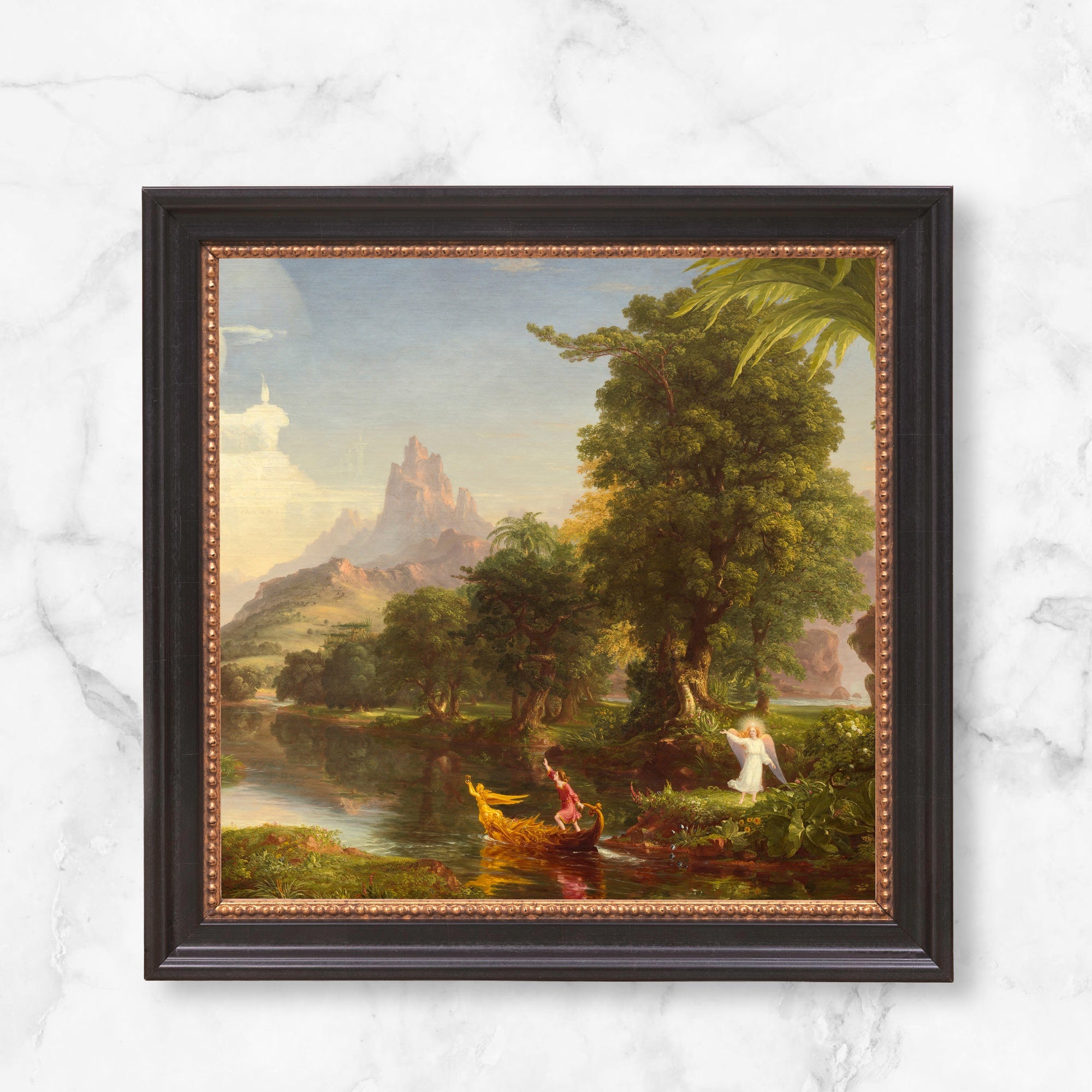 Framed Thomas Cole painting of a river scene with a man in a boat and an angel, dark frame with gold accents.
