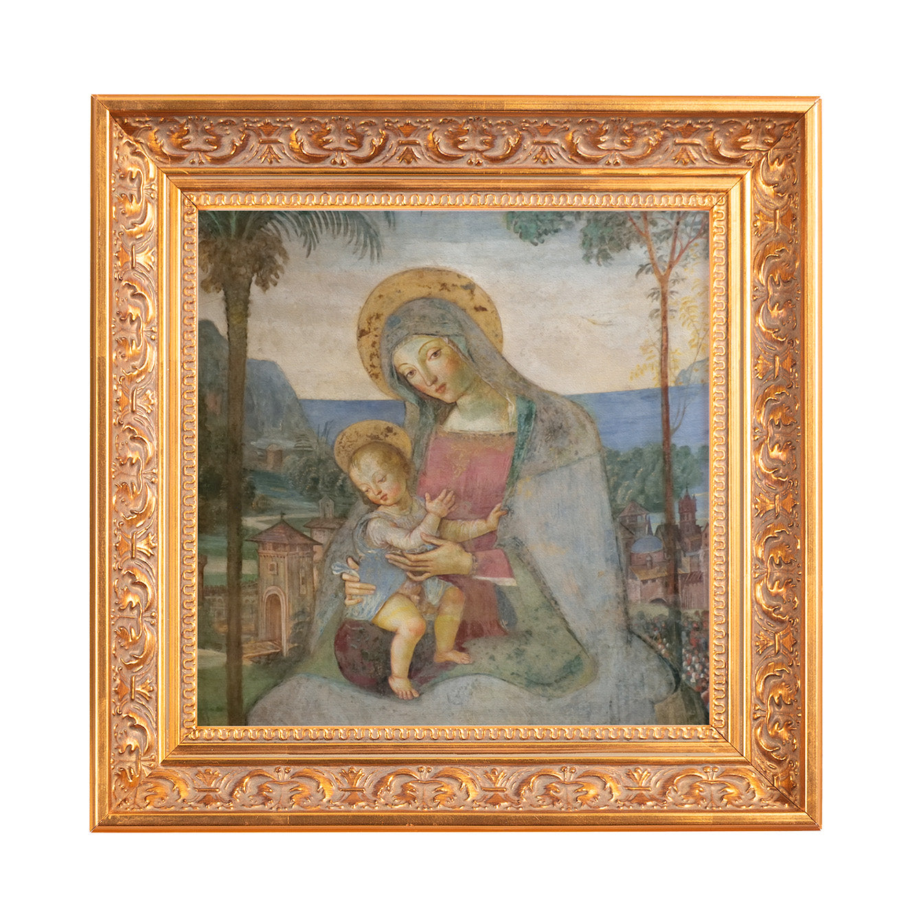 Framed painting of the Madonna and child, soft colors, landscape background, and ornate gold frame.