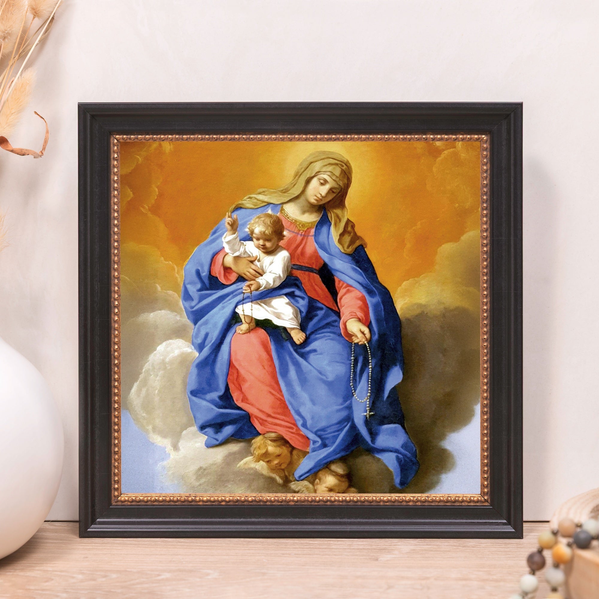 Framed Madonna art print, black wood frame, religious home decor piece.