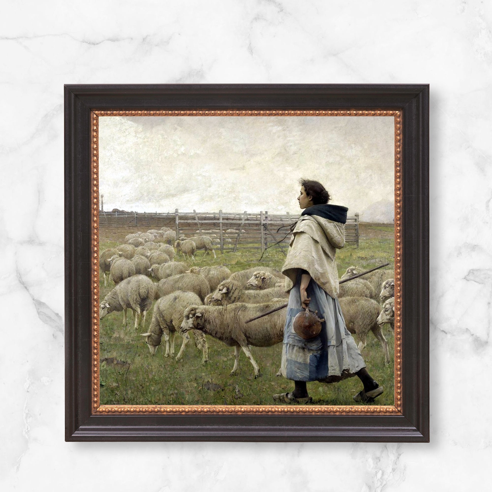 Framed painting of a shepherdess tending sheep in a pastoral scene with a dark wood frame.