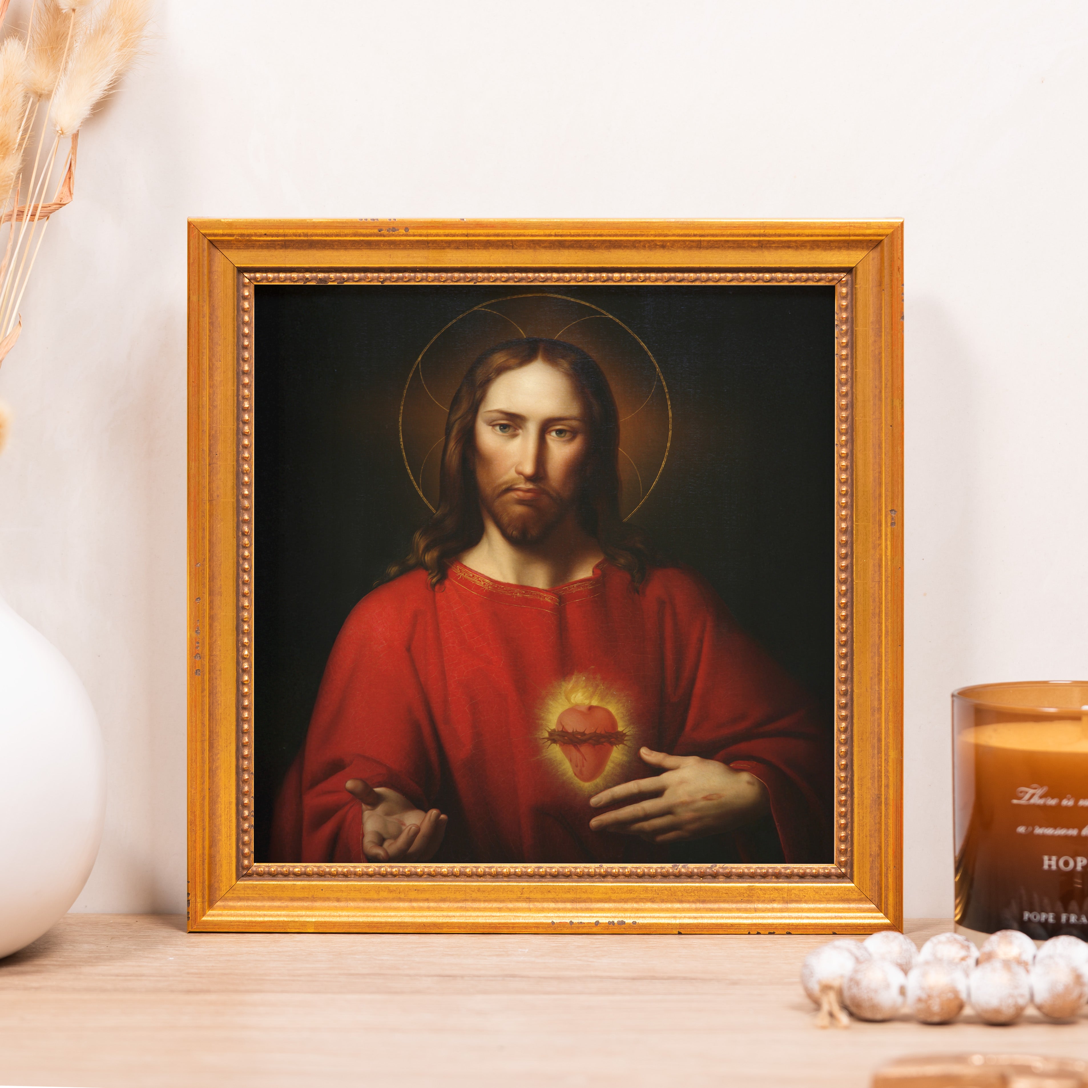 Framed painting of Jesus with a red robe and golden halo.