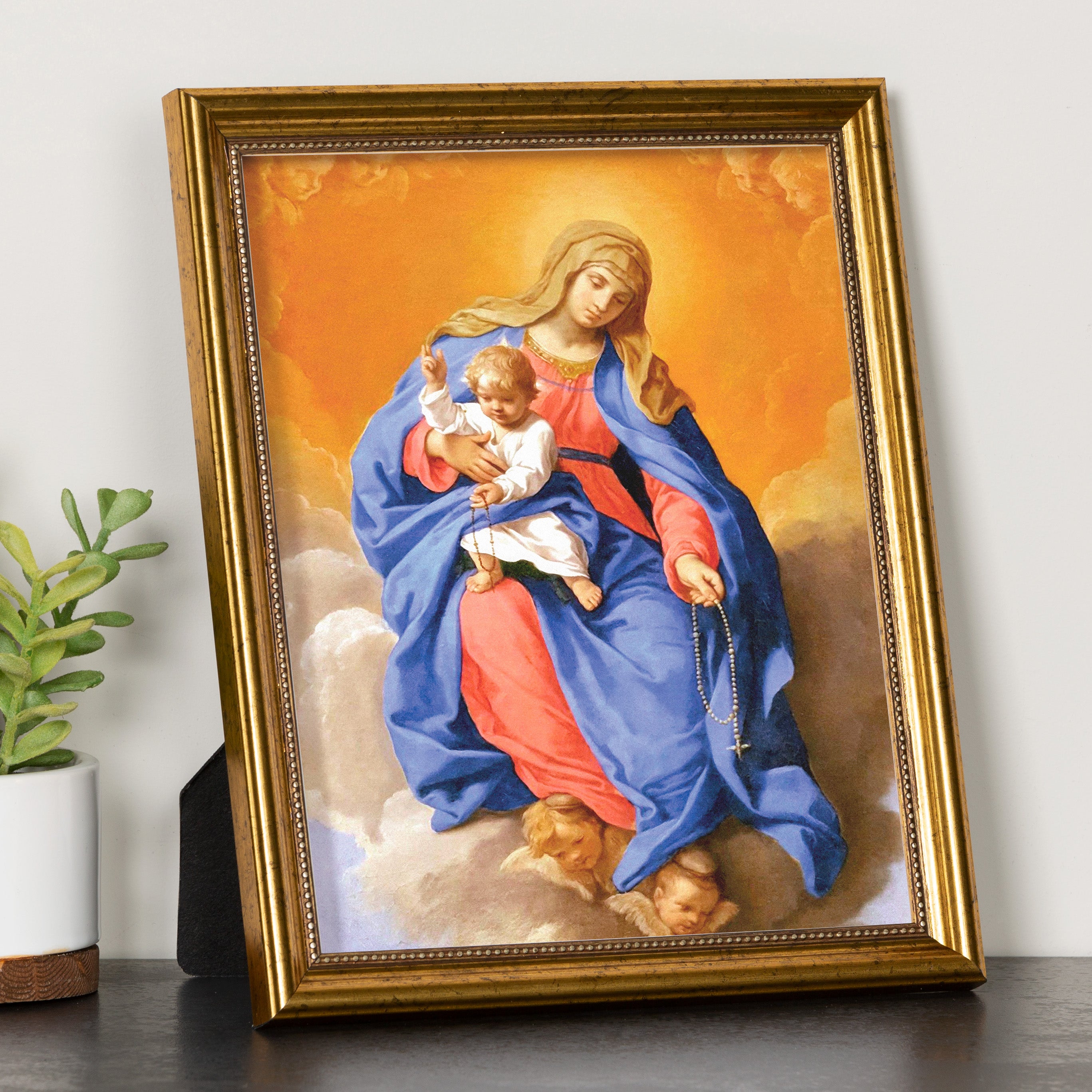 Framed print of the Virgin Mary and baby Jesus, gold frame, warm colors, religious art piece.