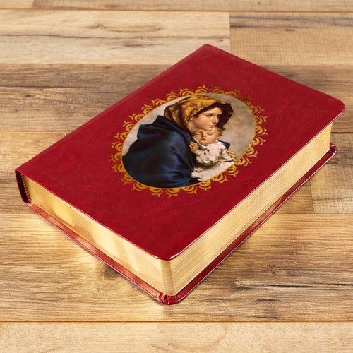 Red, faux leather prayer book with a picture of Mary and baby Jesus and gold-colored page edges.