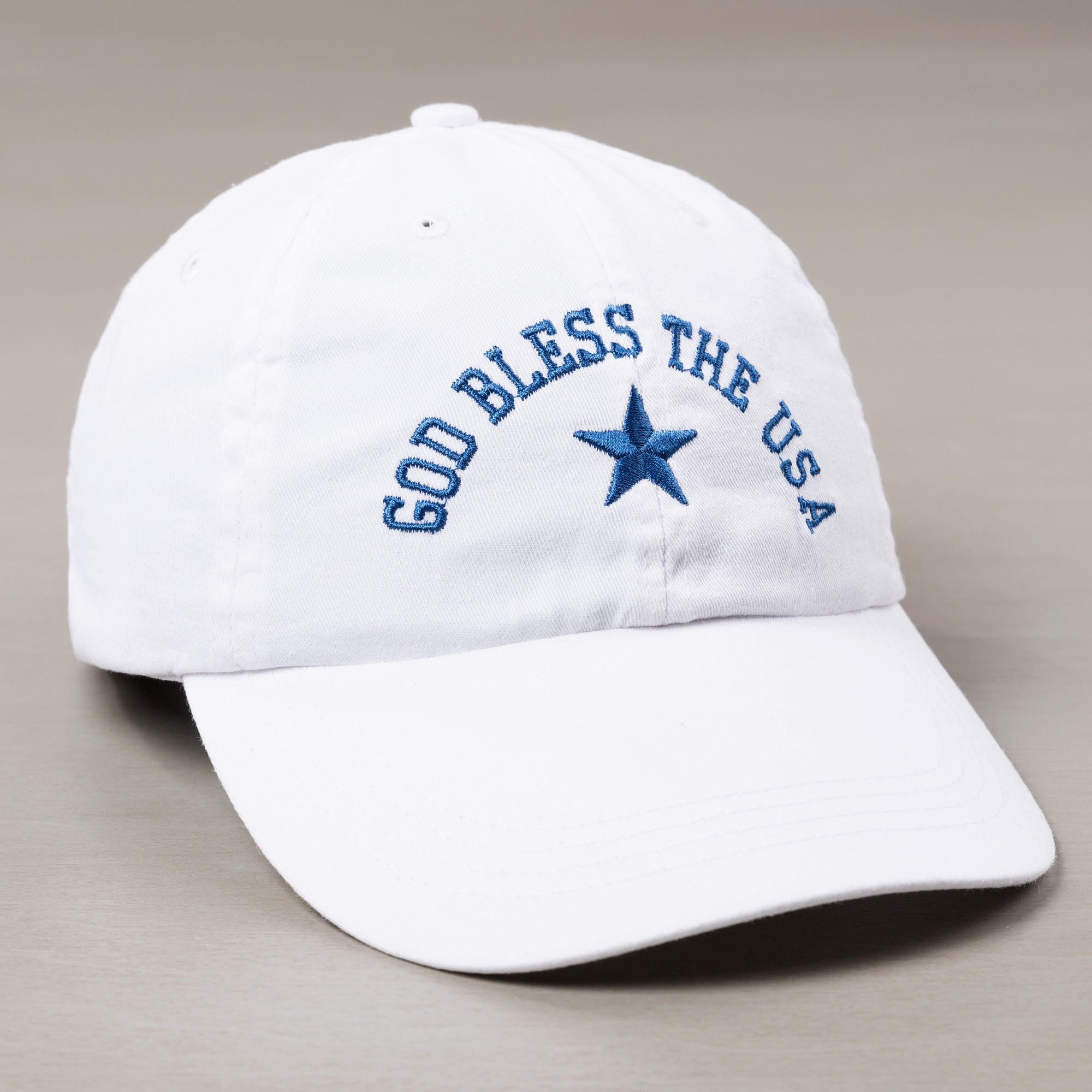 White baseball cap with blue embroidered text "God Bless the USA" and a star.