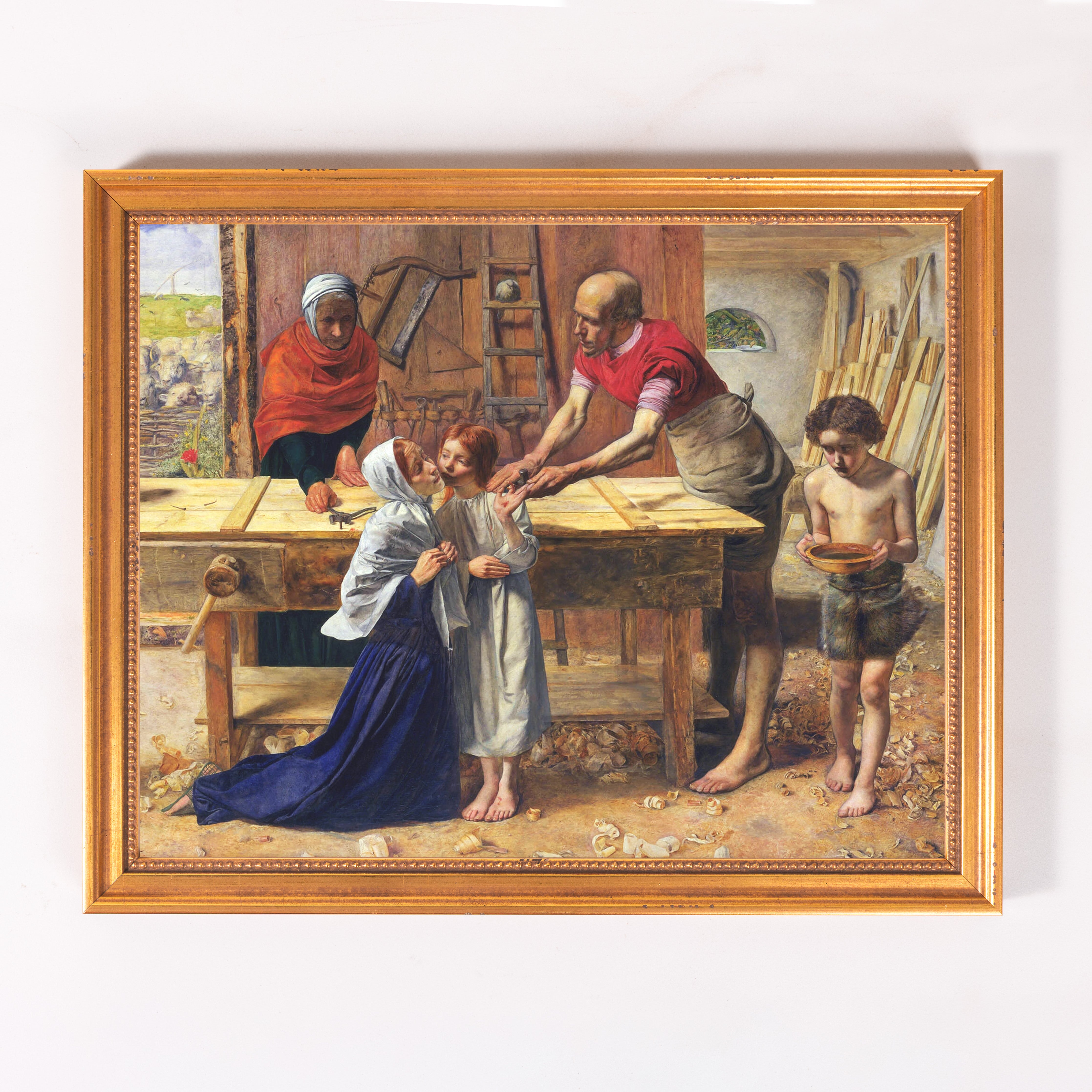 Framed Painting depicts Jesus as a child with his family in a woodshop in earthy tones, gold frame.