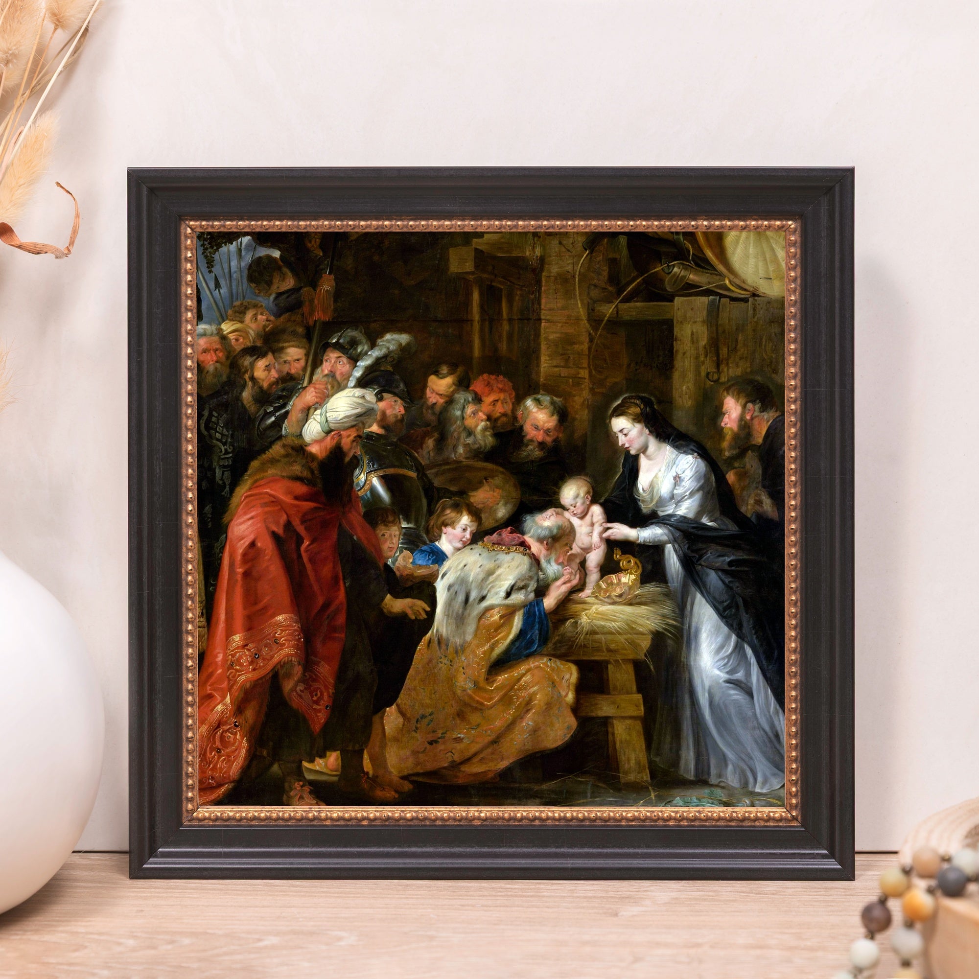 Framed painting depicts the Adoration of the Magi scene in a dark color palette.