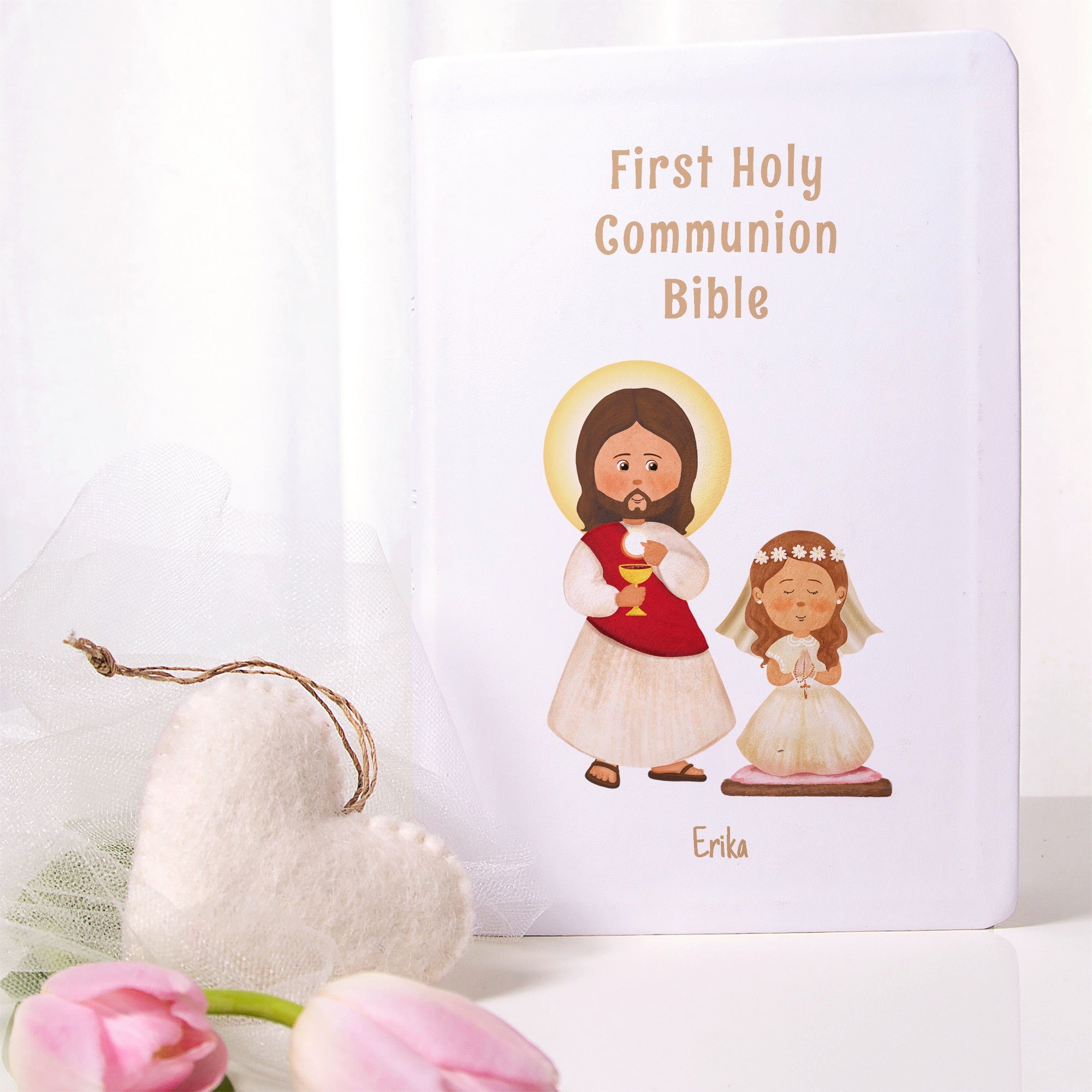 White, First Holy Communion Bible with cartoon Jesus and a girl, personalized with Erika's name.