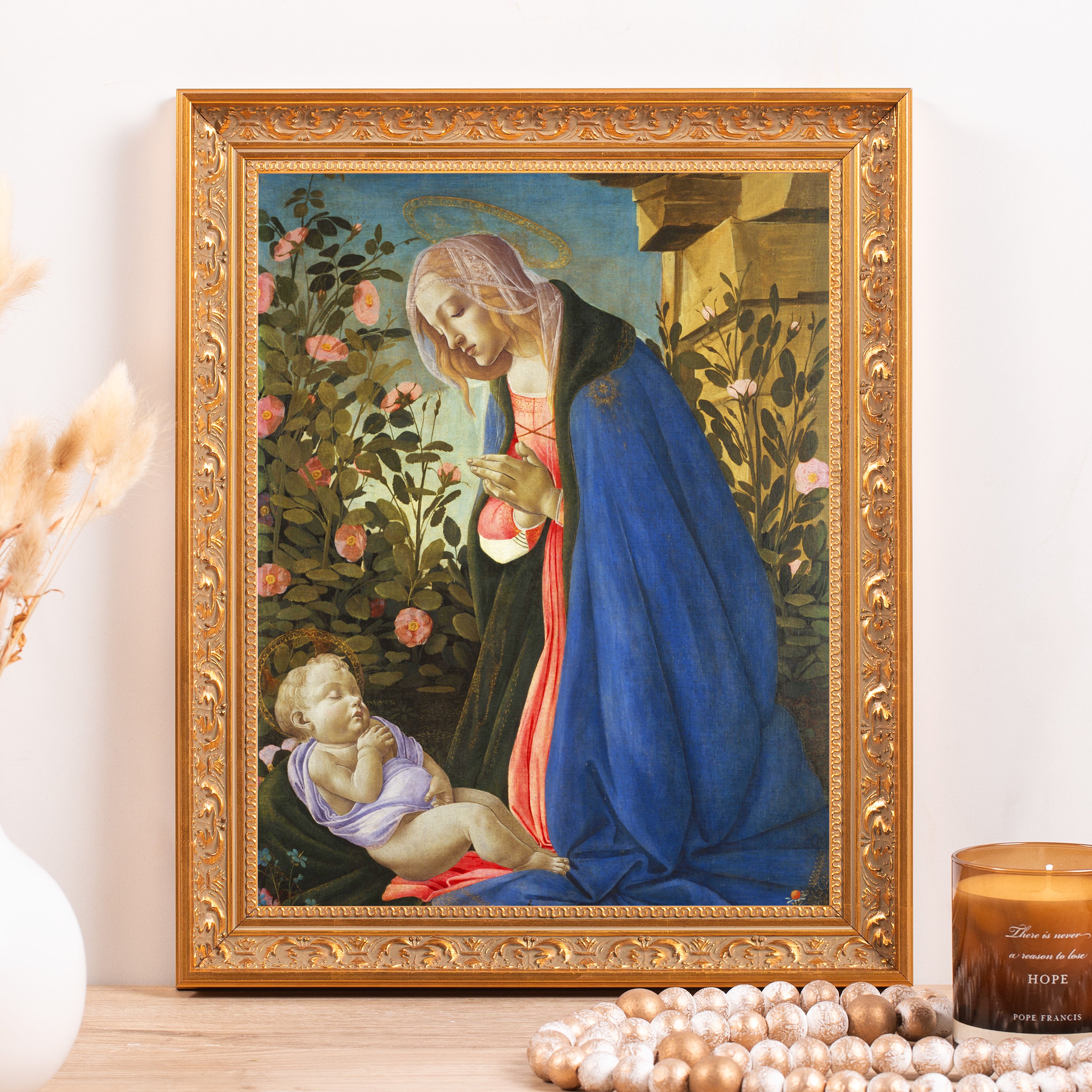 Framed art print of Madonna and Child in a gold frame.
