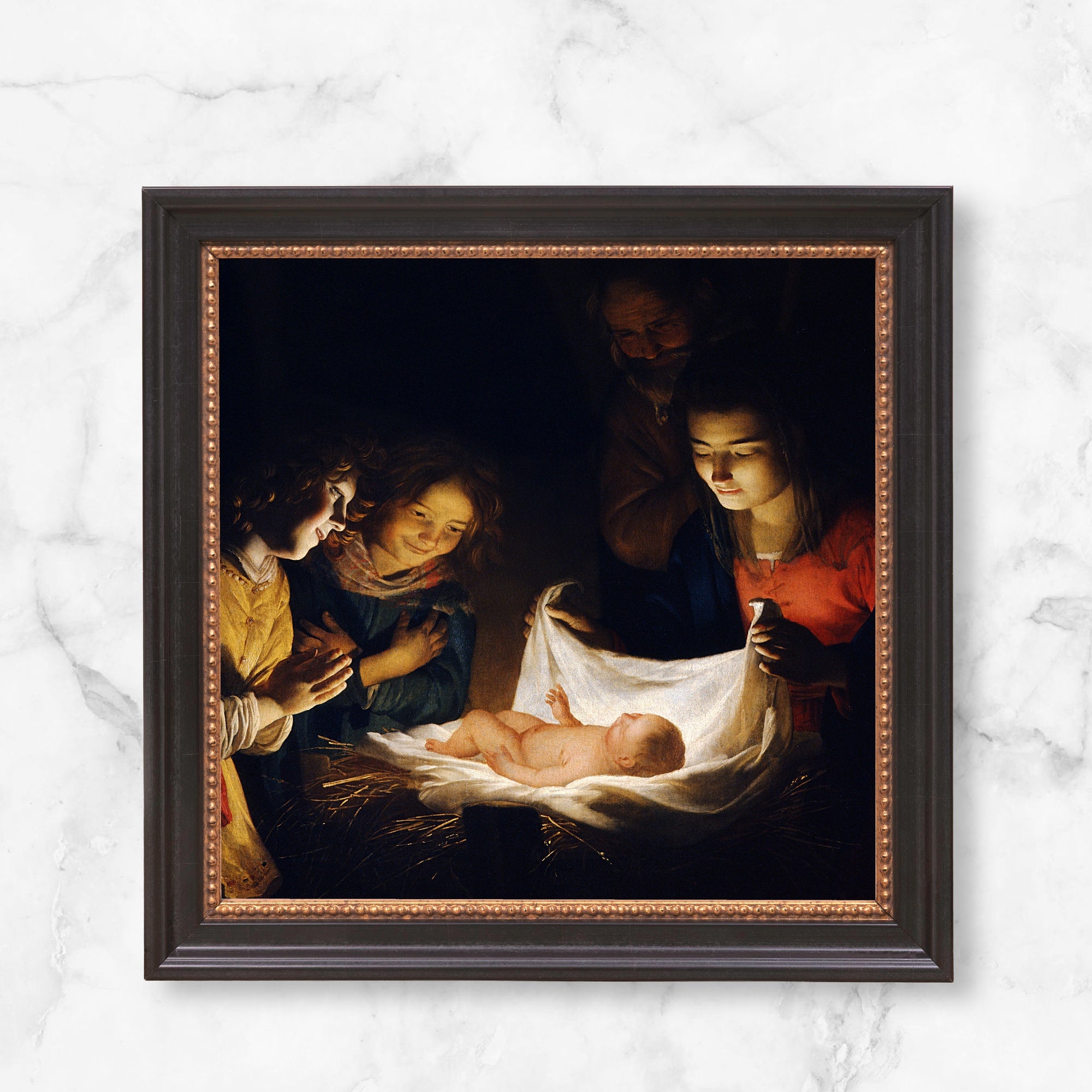 Framed Nativity scene art print; a dark oil painting with religious subject matter, presented in a decorative, dark brown frame.