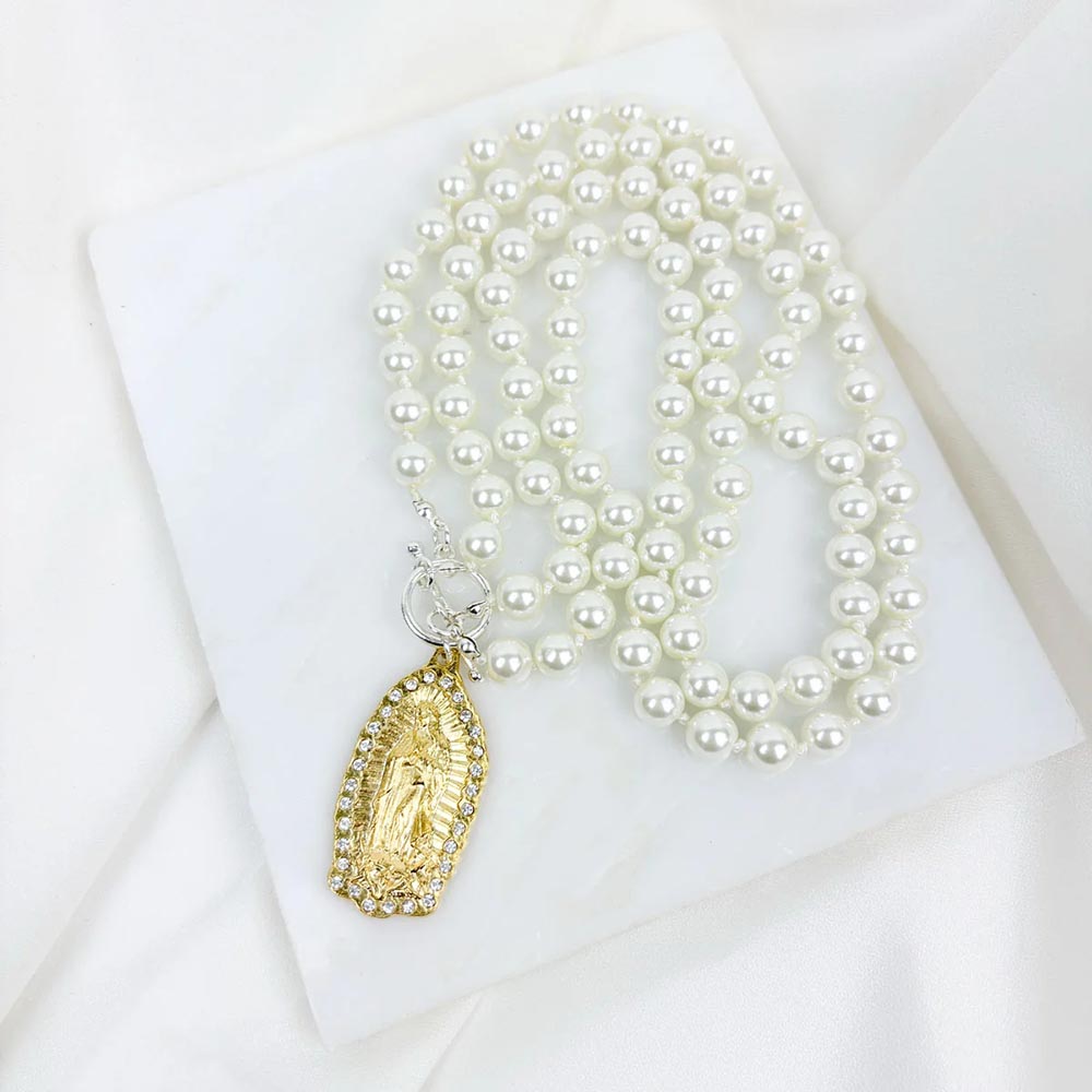 Necklace with white pearls and gold pendant.