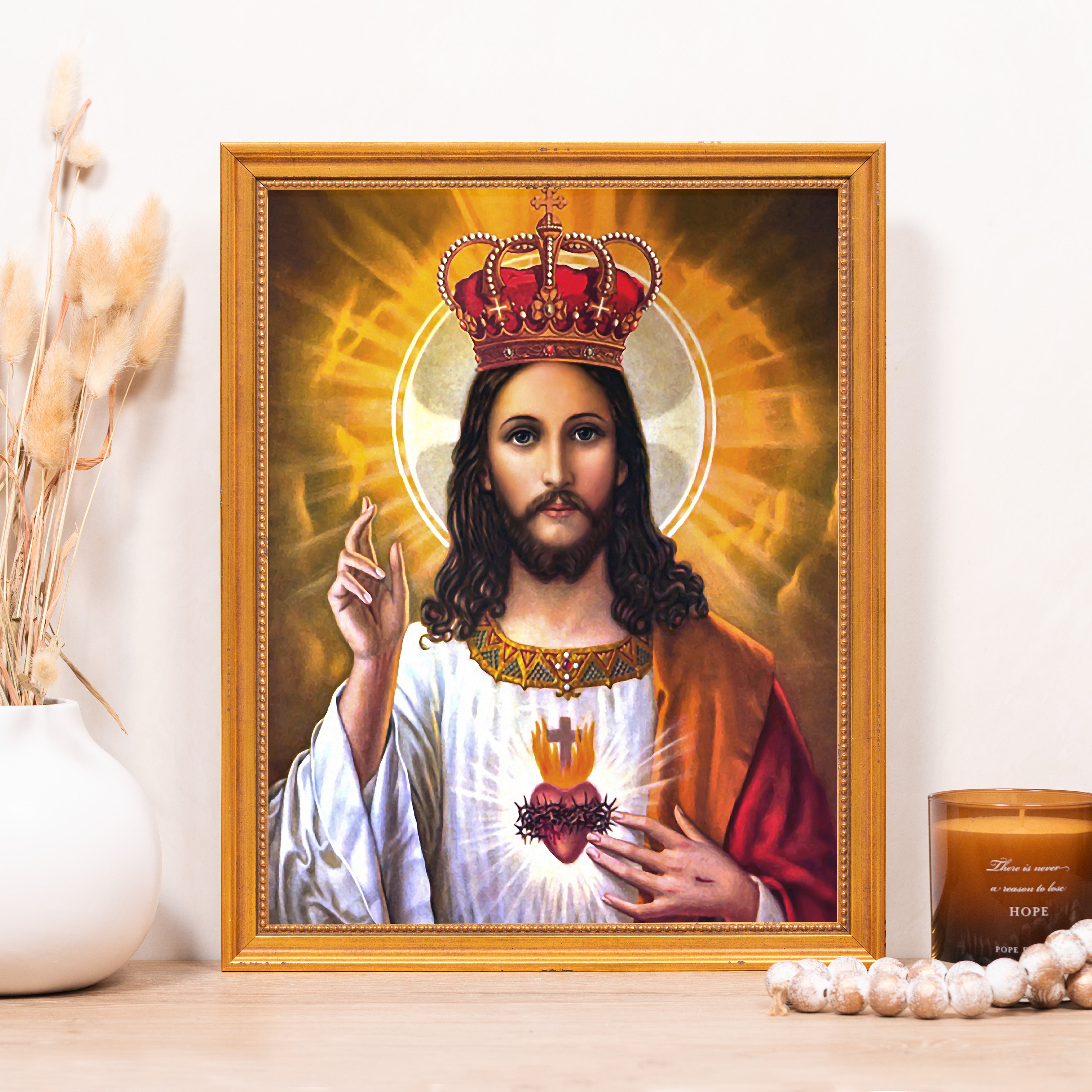 Framed Portrait of Jesus Christ with crown and sacred heart in gold frame, used as home decor for Catholic devotees.