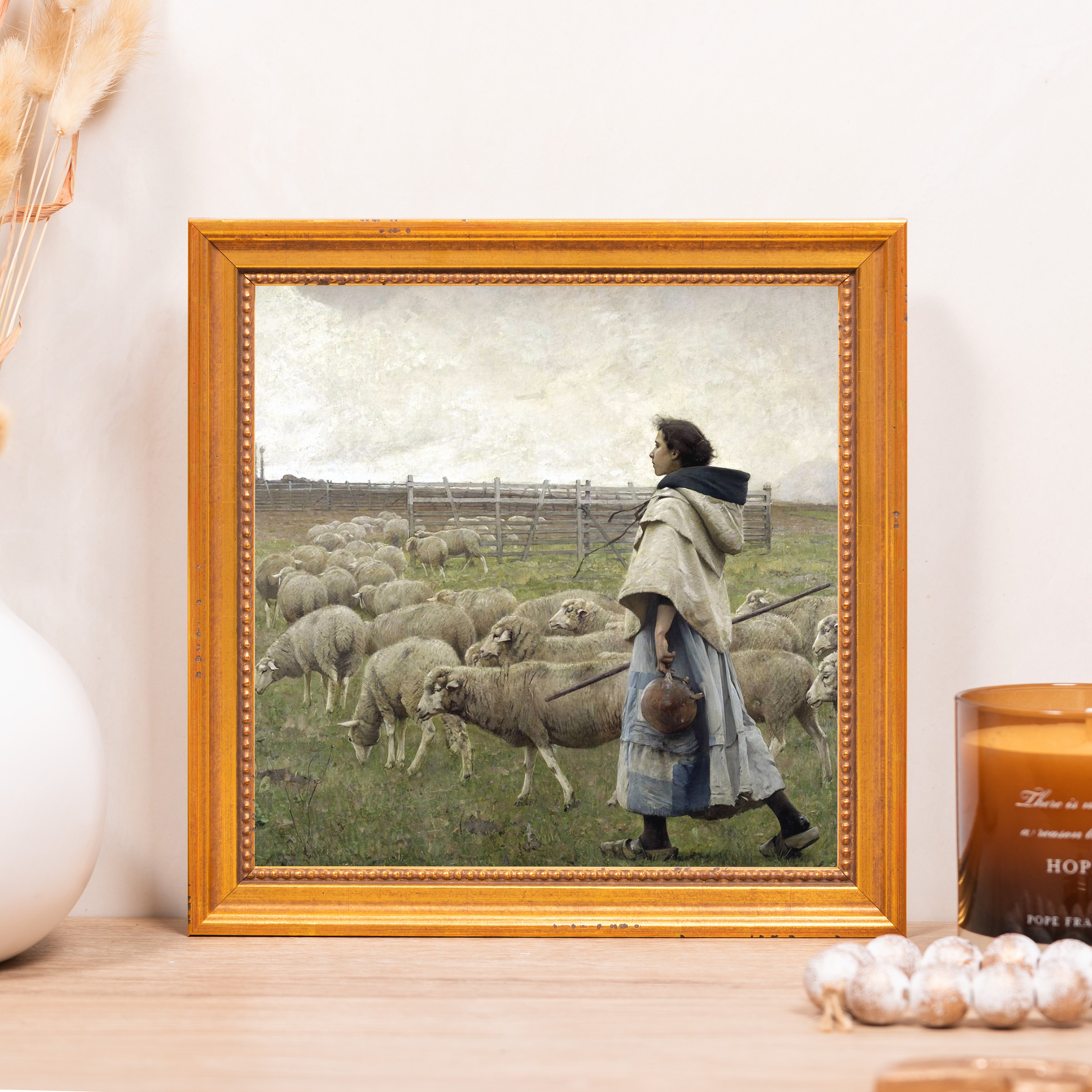 Framed painting of a shepherd girl with sheep, set in gold frame, vintage style.