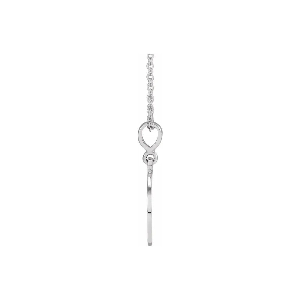 Necklace with simple heart pendant made of white metal hanging from thin chain.