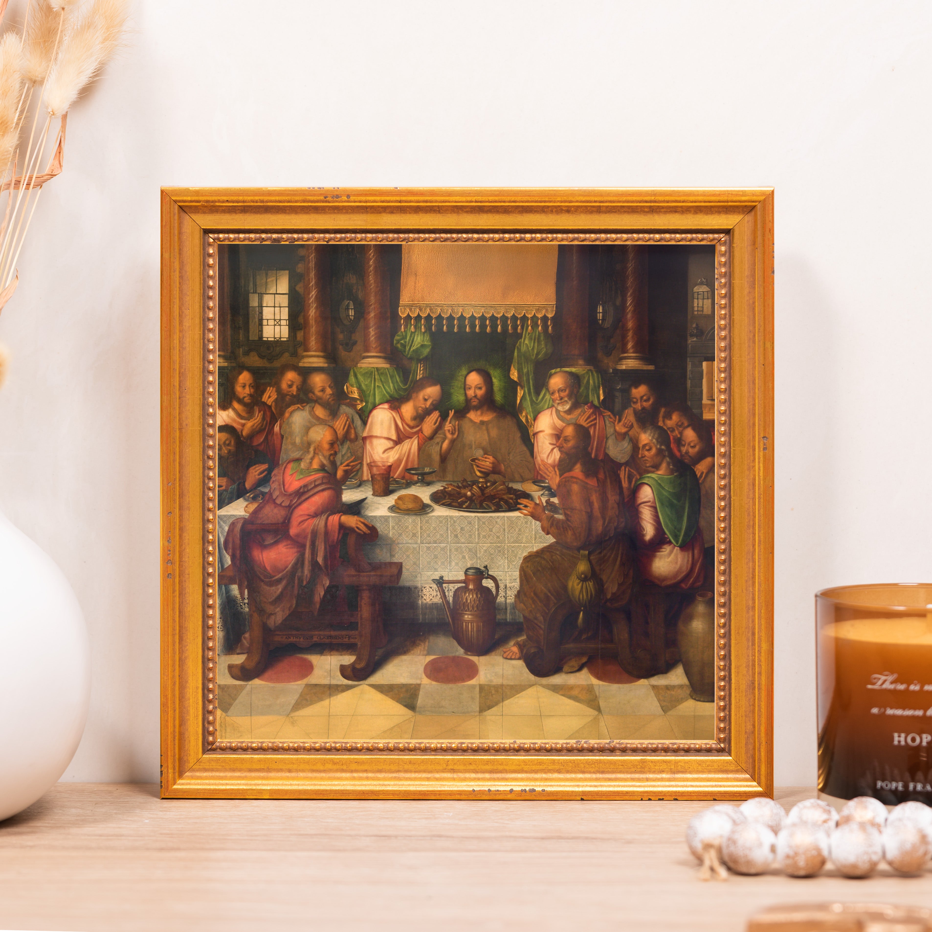 Framed artwork showing The Last Supper with Jesus and disciples; gold frame.