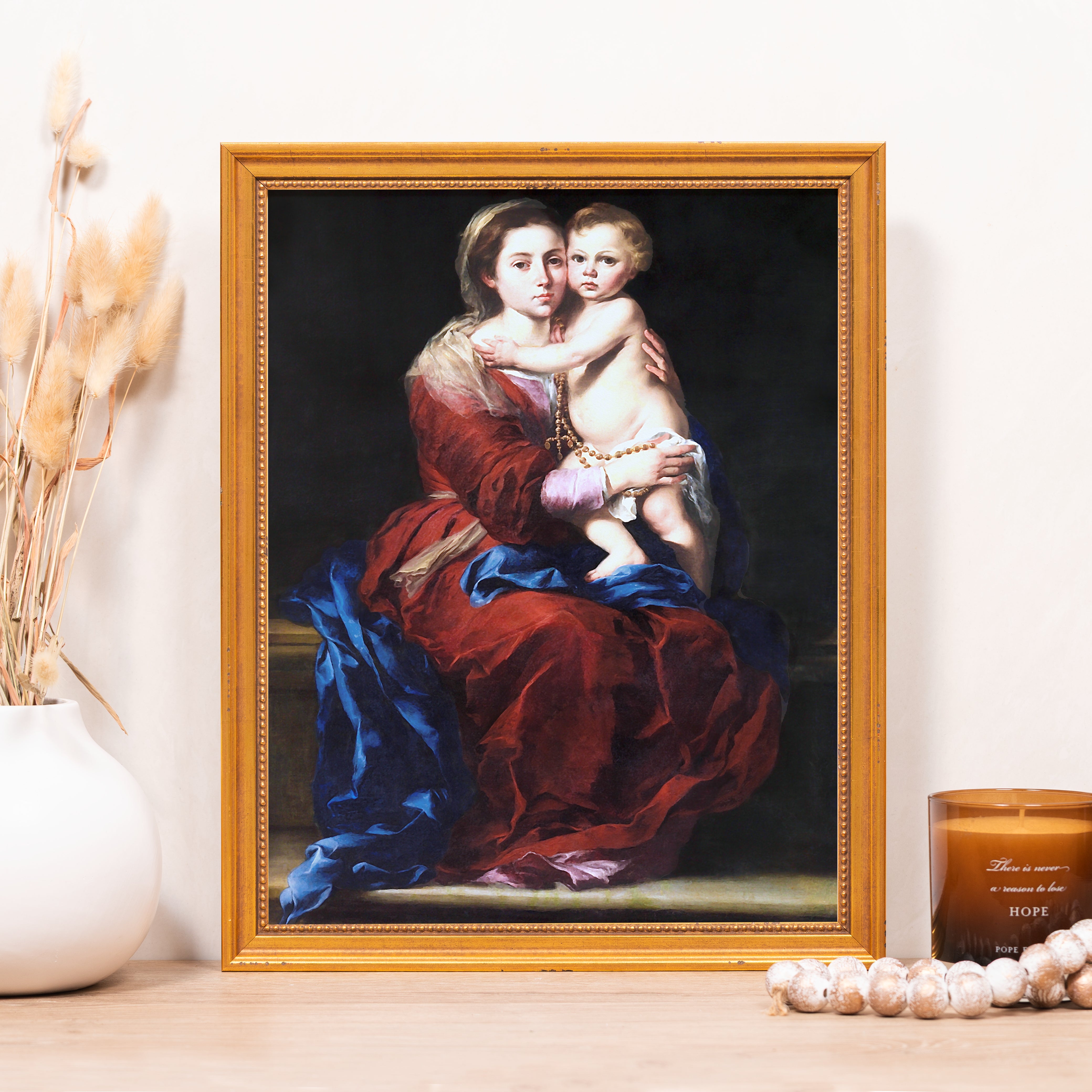 Framed art print featuring Mary and baby Jesus in traditional style, gold frame, warm colors, religious.