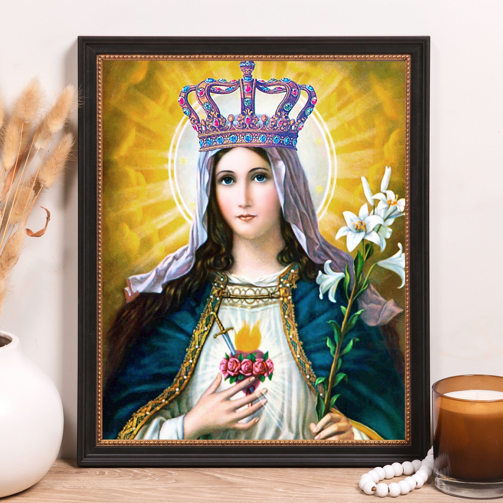 Framed print of Virgin Mary with a jeweled crown, heart with sword, holding lilies, in a gold and yellow background.