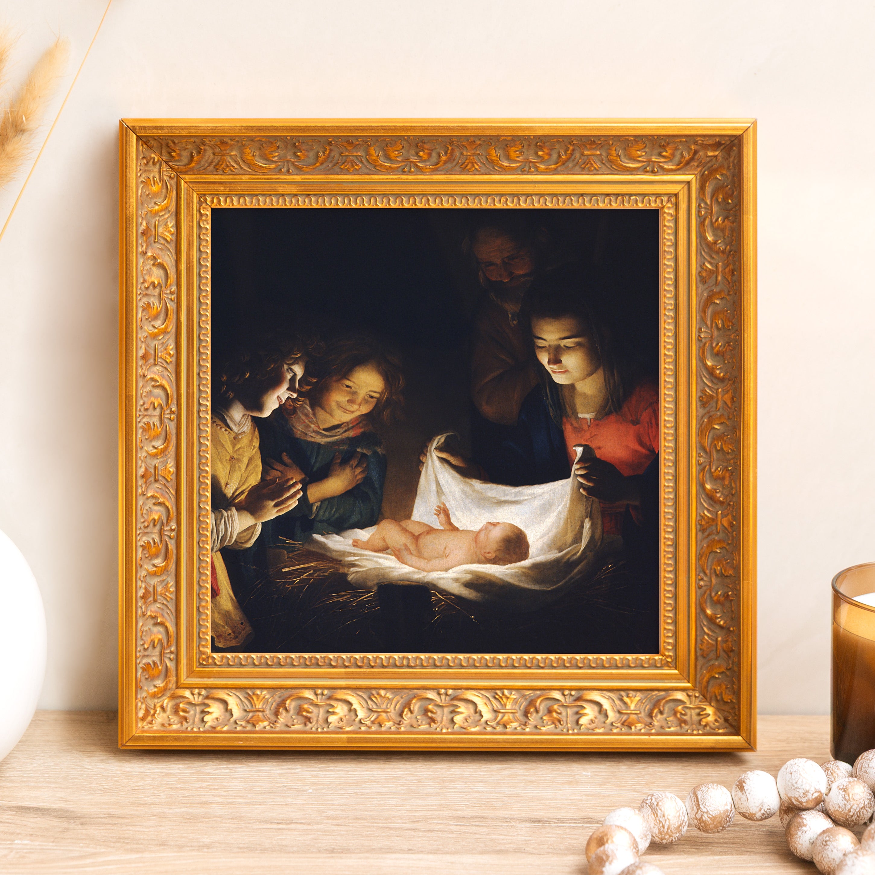 Framed "Nativity" art print for wall display; dark painting with gold ornate frame.