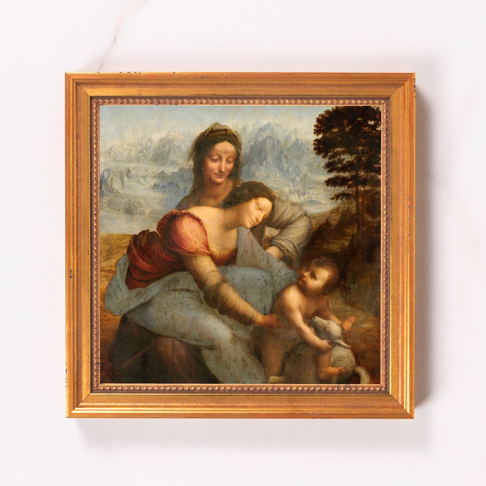 Framed painting depicts figures of Mary, Anne, and infant Jesus in a Renaissance style with a golden frame.