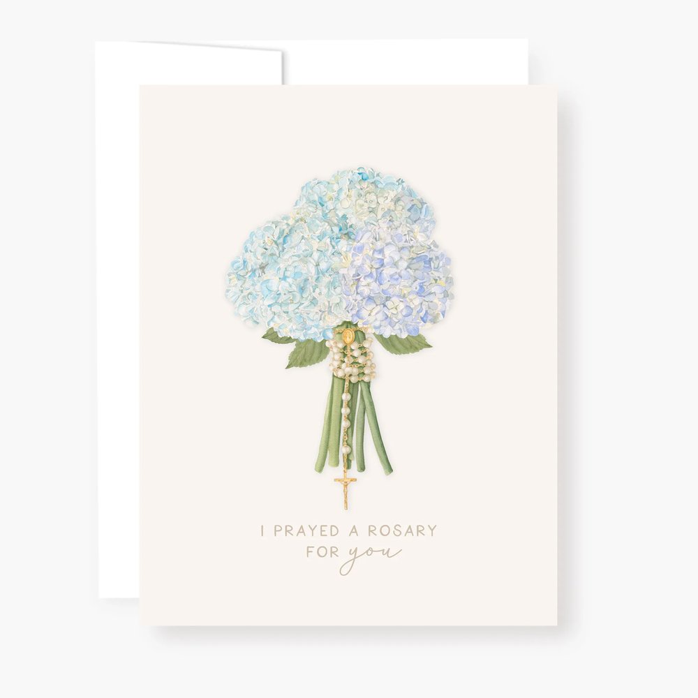 Greeting card with "I prayed a rosary for you" and a blue hydrangea and gold rosary bouquet design.