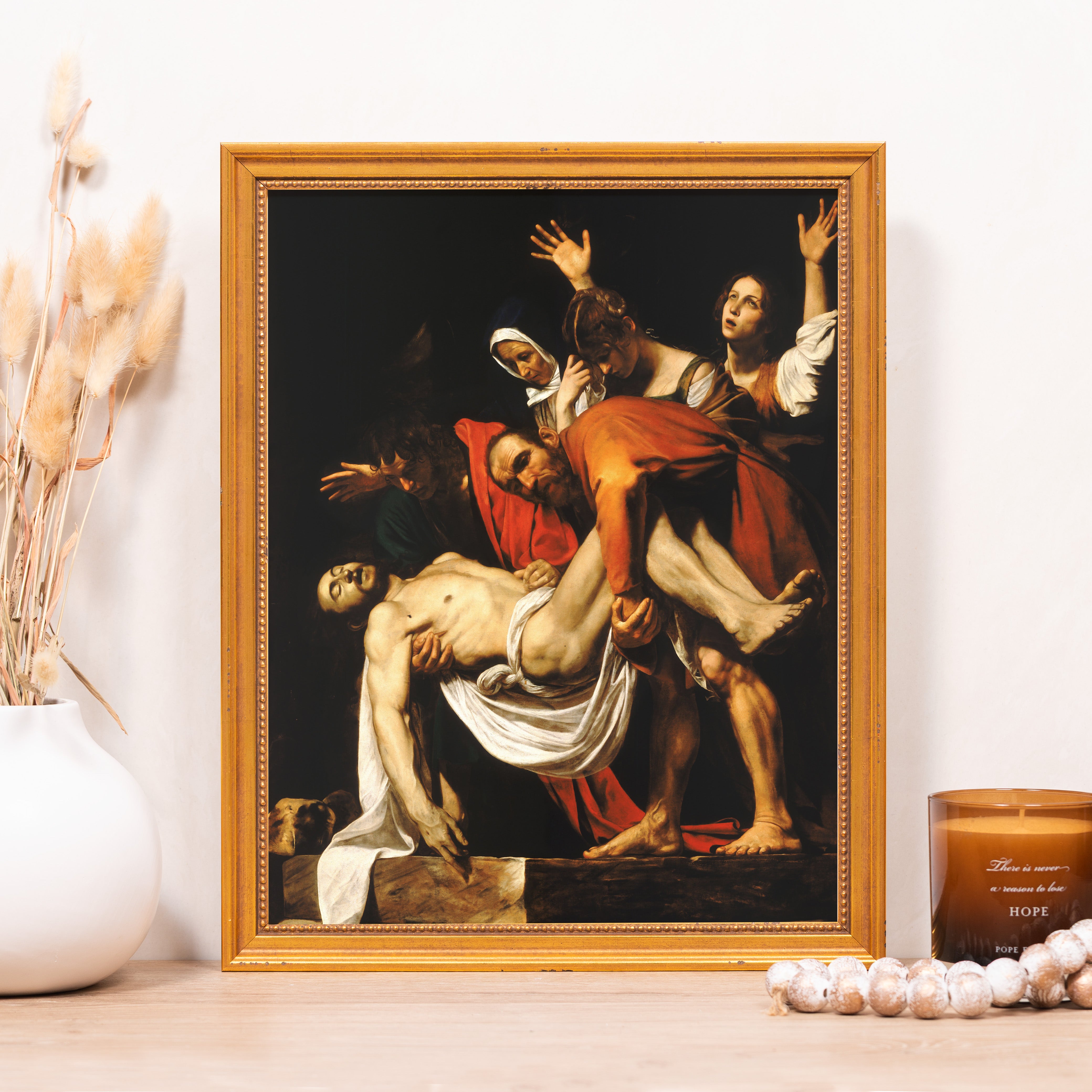 Framed "Entombment of Christ" print features baroque style in a gold frame.