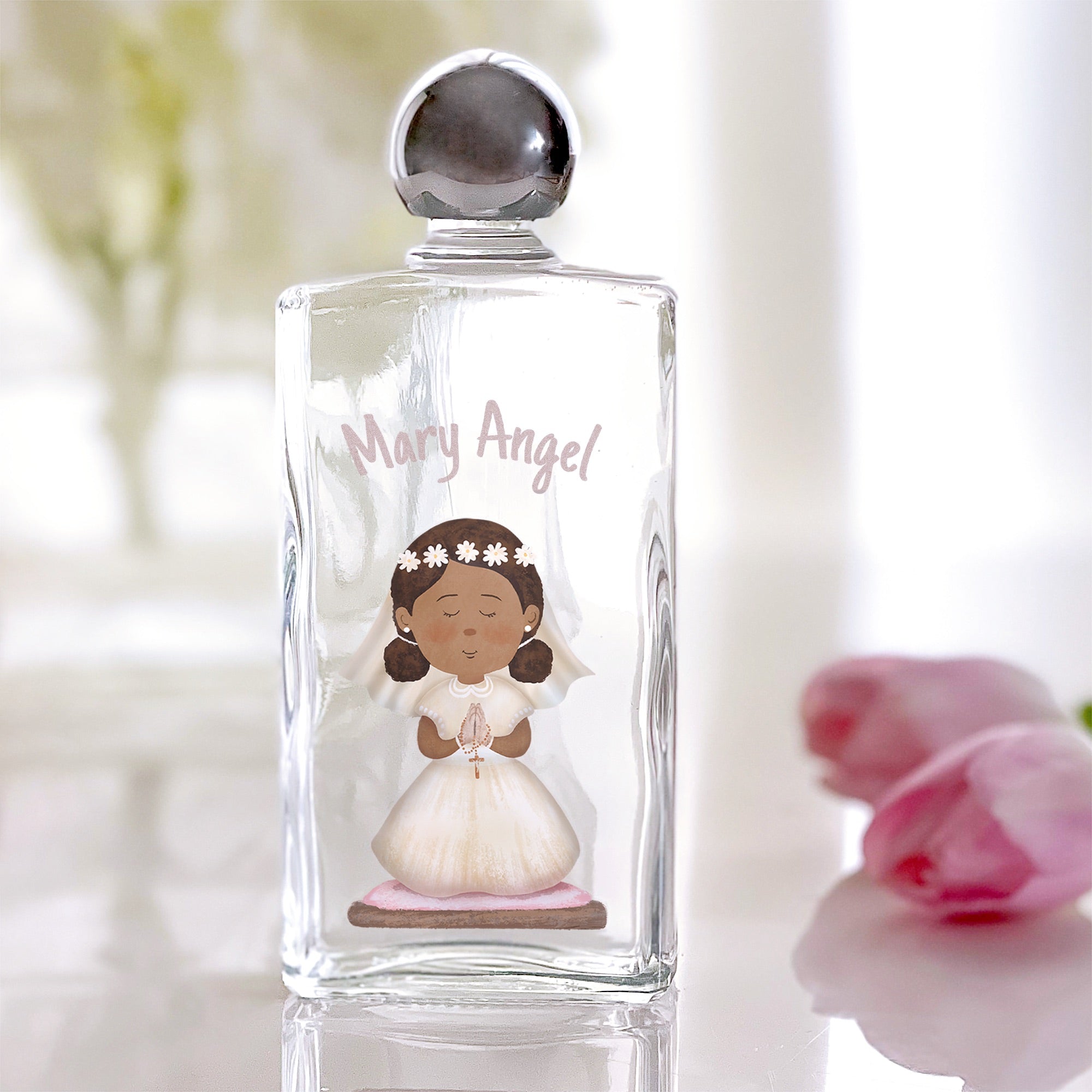 Glass holy water bottle with silver stopper, featuring "Mary Angel" and a dark-skinned girl in white dress graphic print.