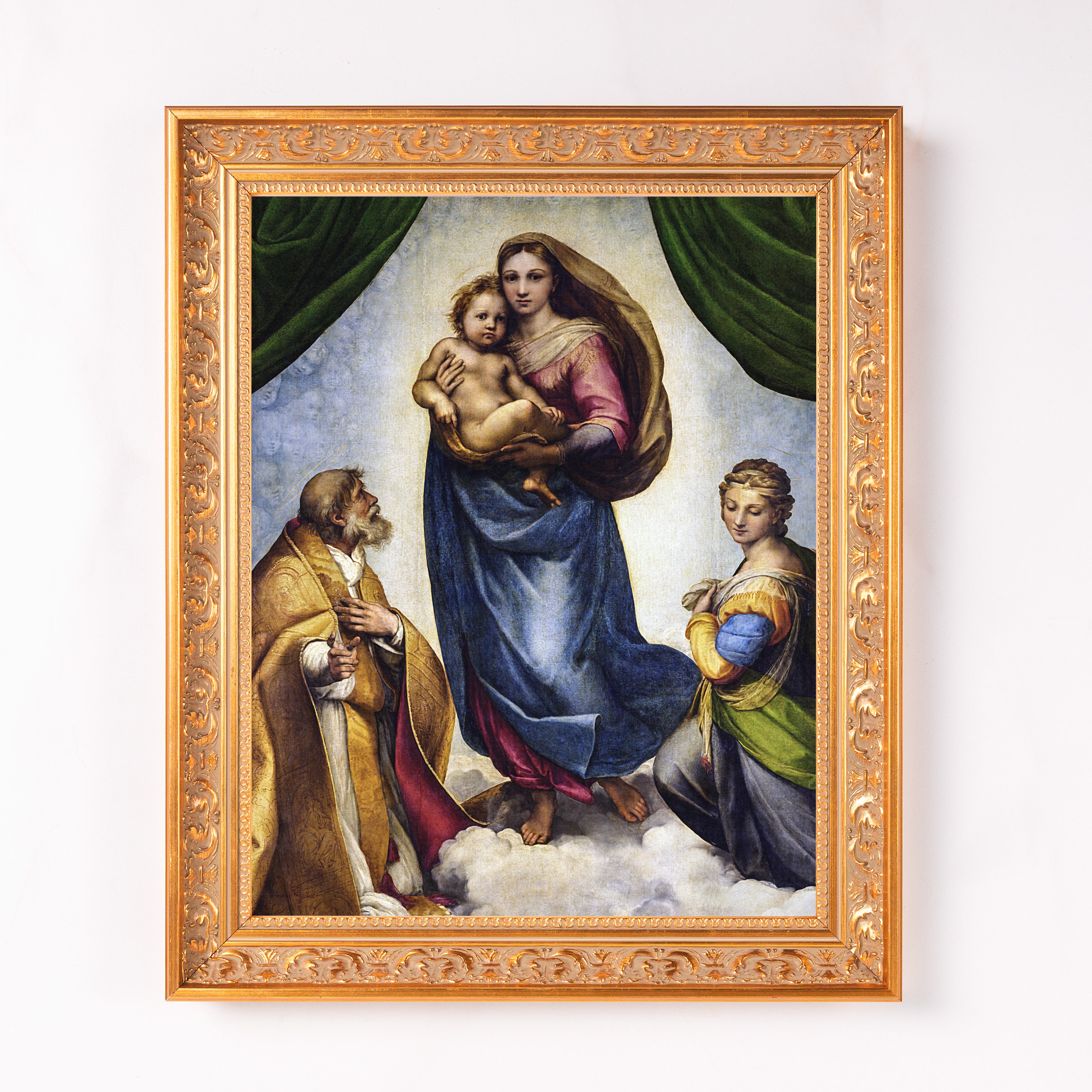 Framed Raphael print of Madonna, child, and saints in blue, pink, and gold colors with ornate gold frame.