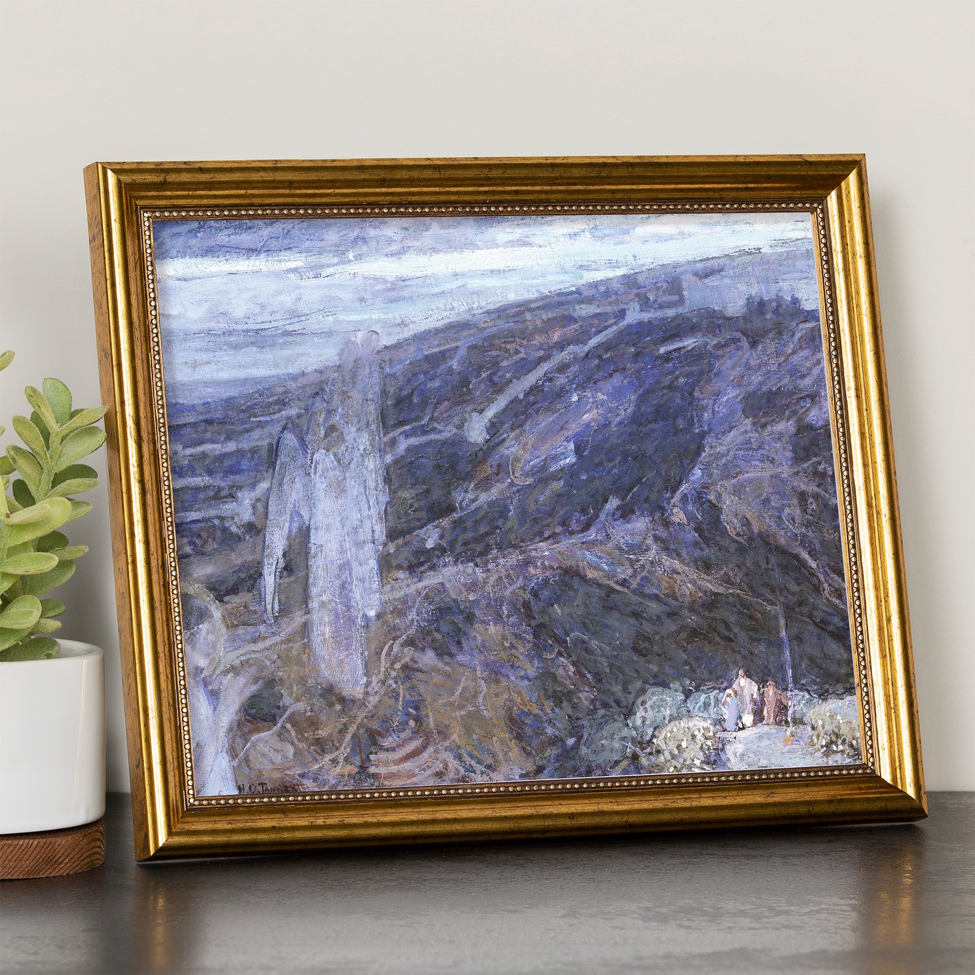 Framed landscape painting in a gold frame featuring blues, whites, and browns.