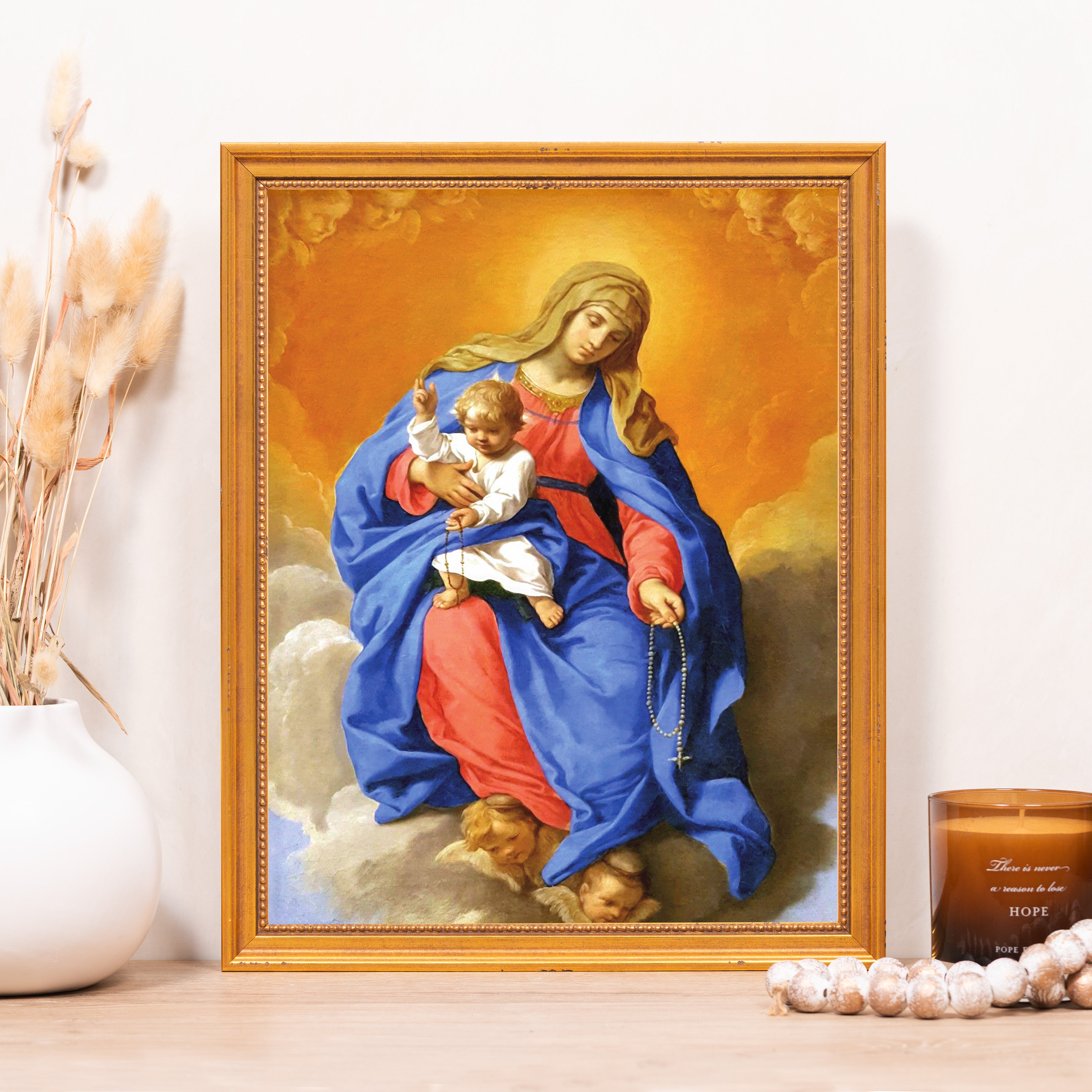 Framed religious art print of Mary holding infant Jesus with gold frame.
