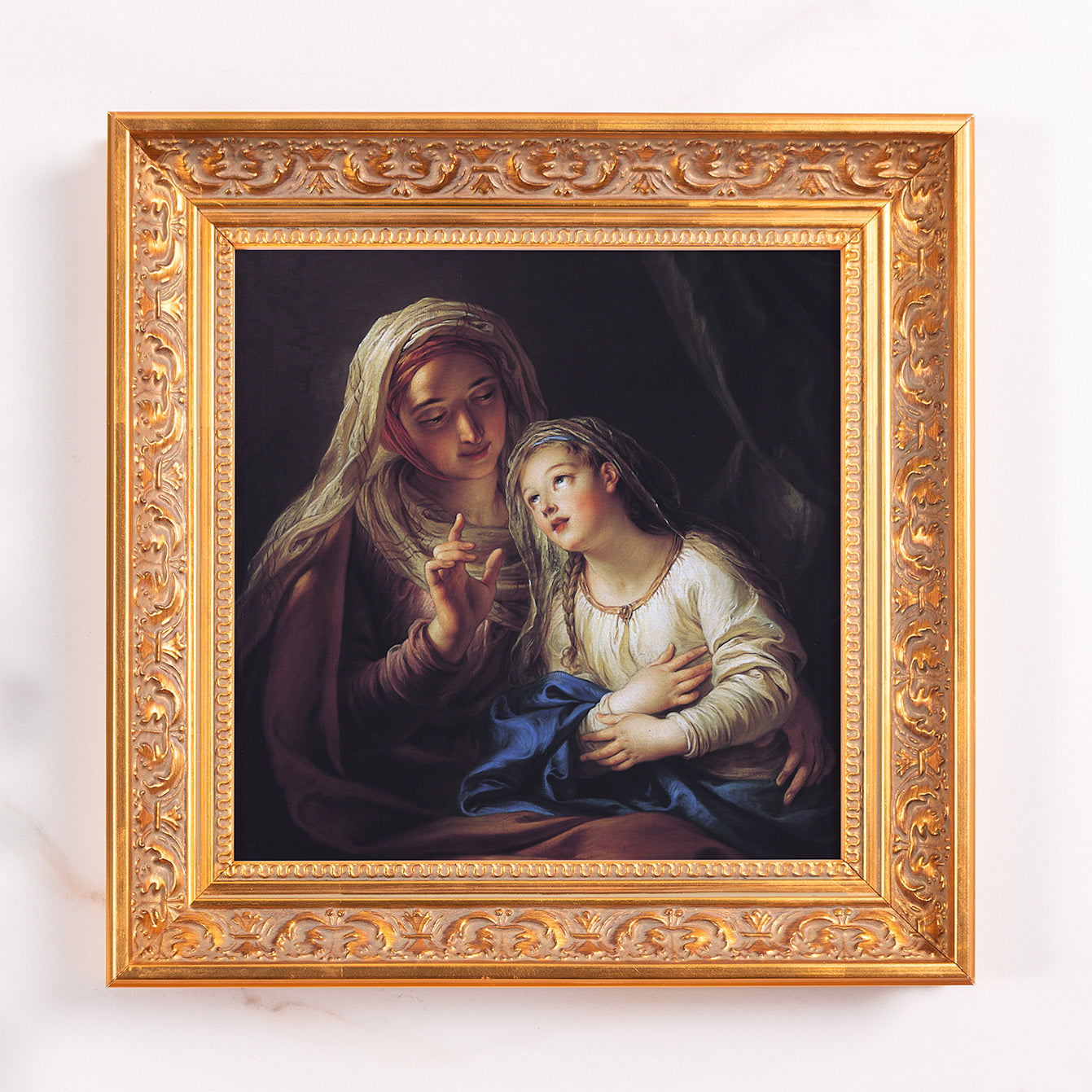Framed painting of Mary teaching the Virgin. Ornate, gold frame. Oil style.