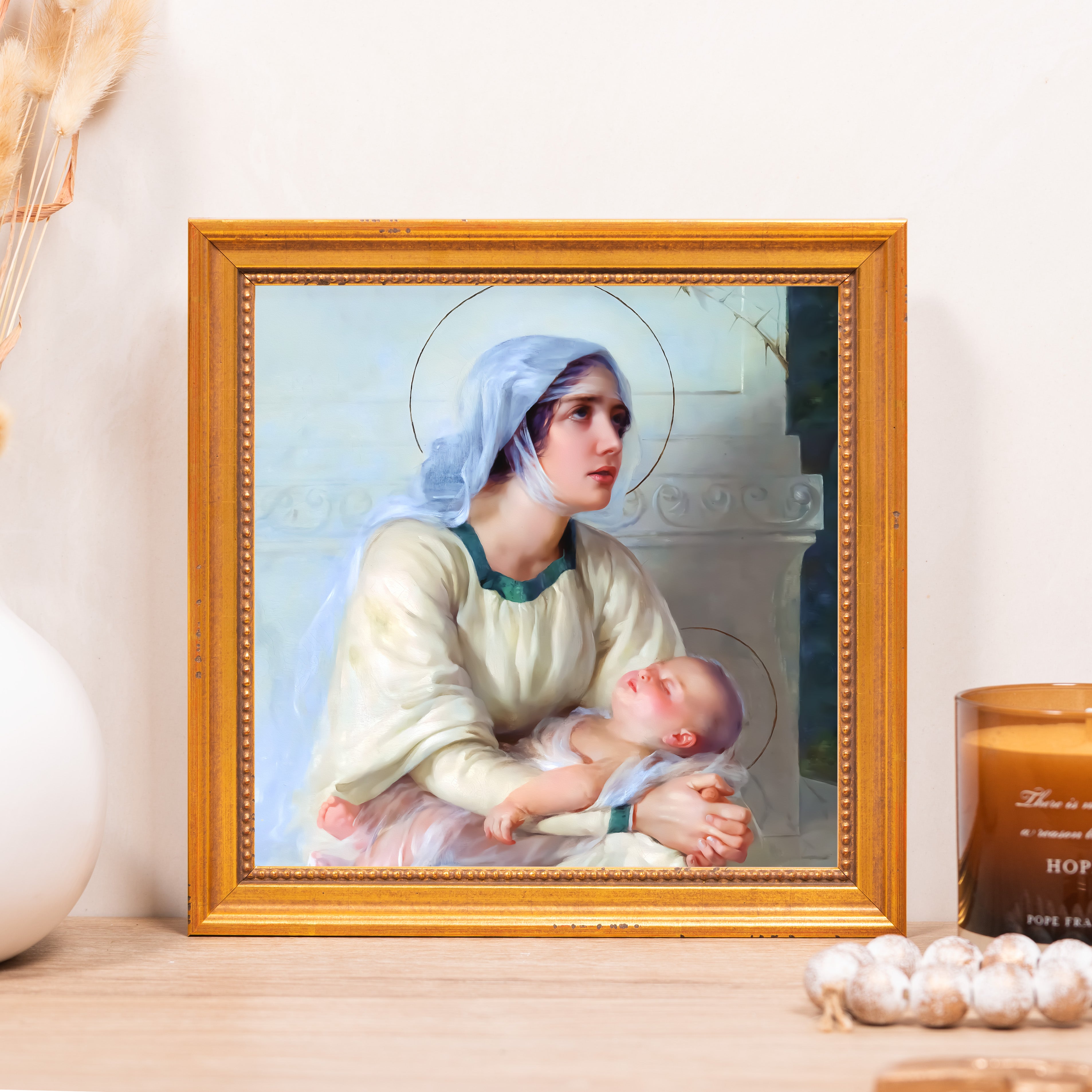 Framed print of Mary and Jesus in an ornate gold frame.
