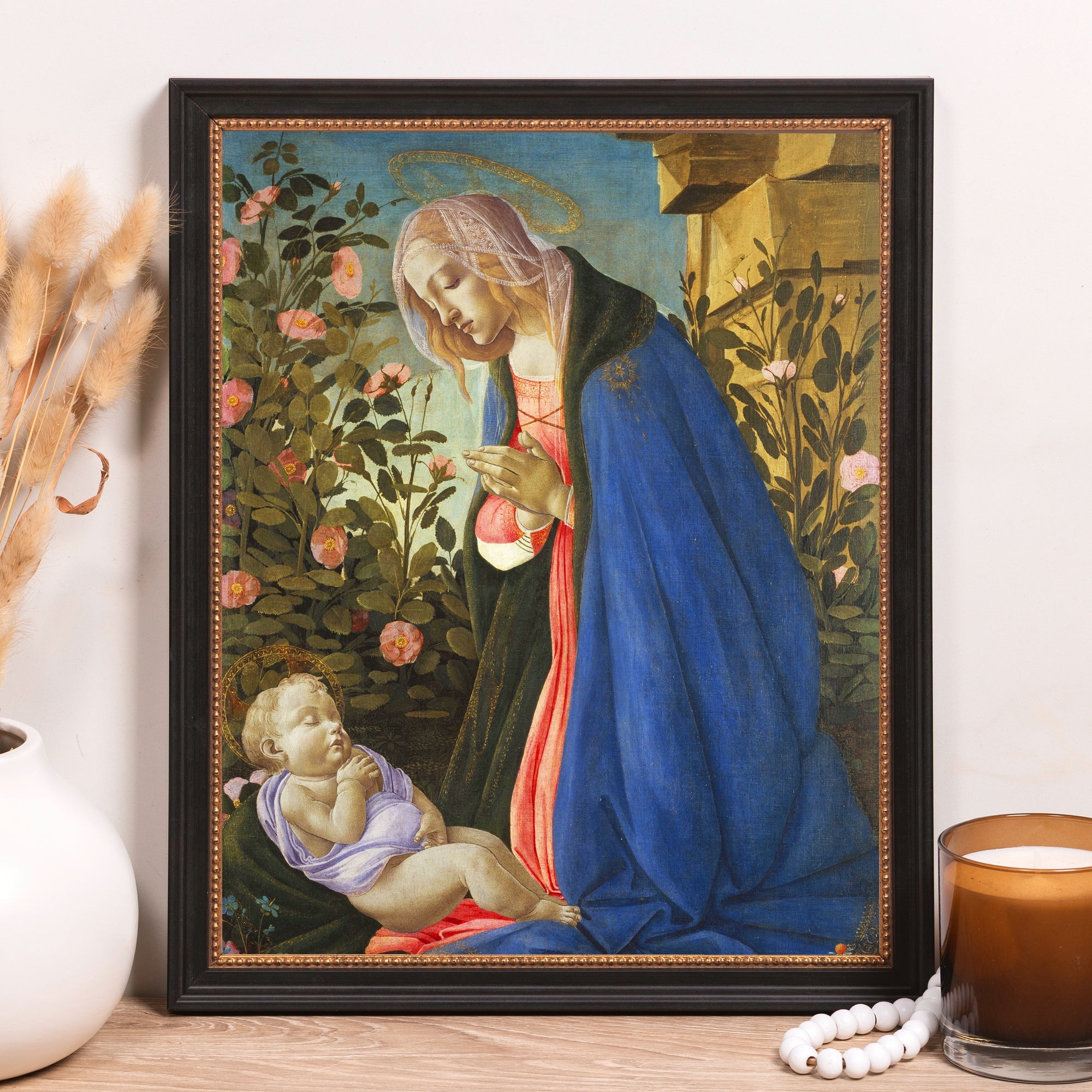 Framed painting of Madonna and Child, in a Renaissance style with blue and green tones.