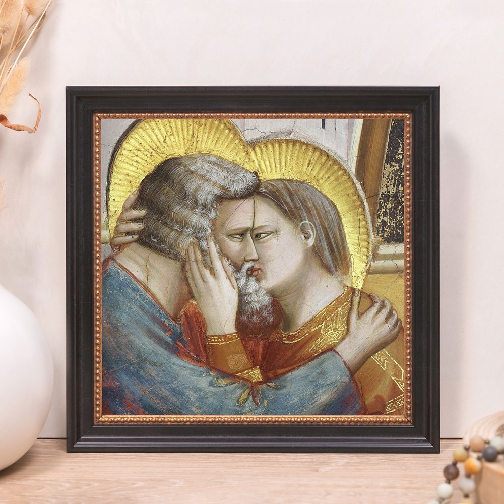 Framed art print depicts kissing figures with golden halos in medieval style and black frame.